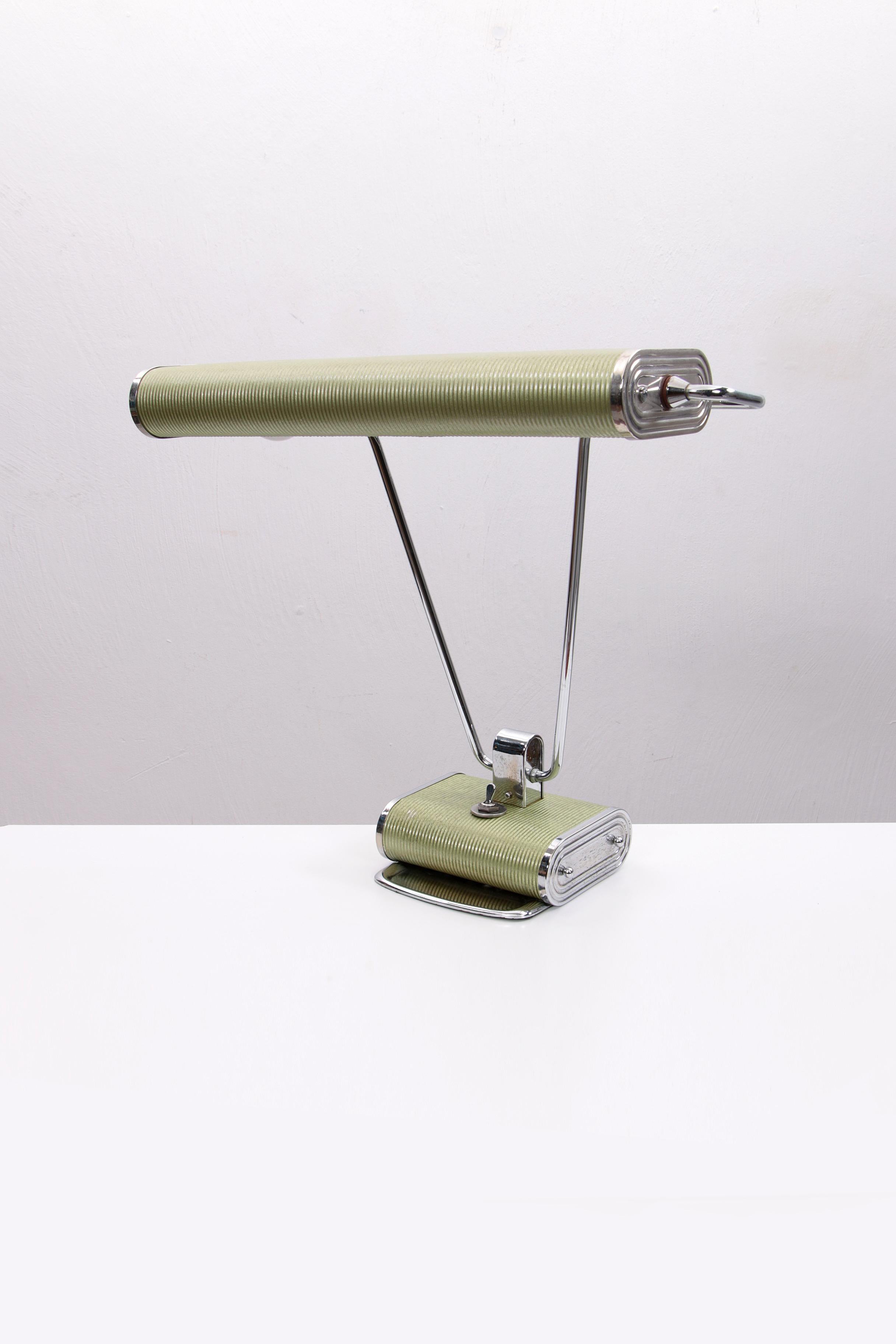 A modernist desk lamp designed for Jumo by Eileen GrEy. A very pure unrestored copy. This one has a beautiful metallic green color. Very rare copy.

The switch also works as it should.
It is made with a combination of chrome plated brass tube,