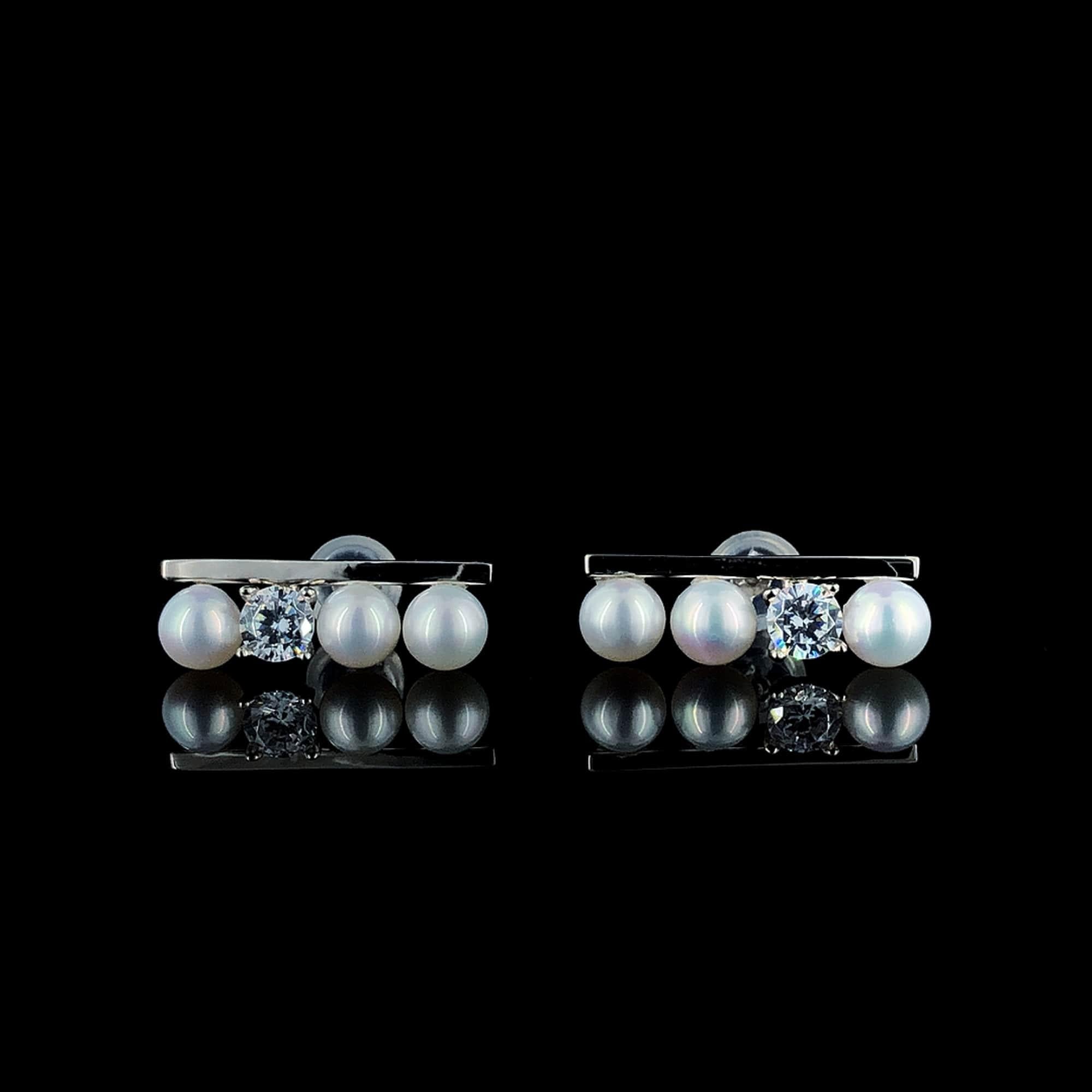 Elevate your style with these exquisite Art Deco-inspired freshwater pearl stud earrings, adorned with a brilliant cubic zirconia diamond, all set in lustrous sterling silver. Whether you're dressing up for a glamorous event or adding a touch of