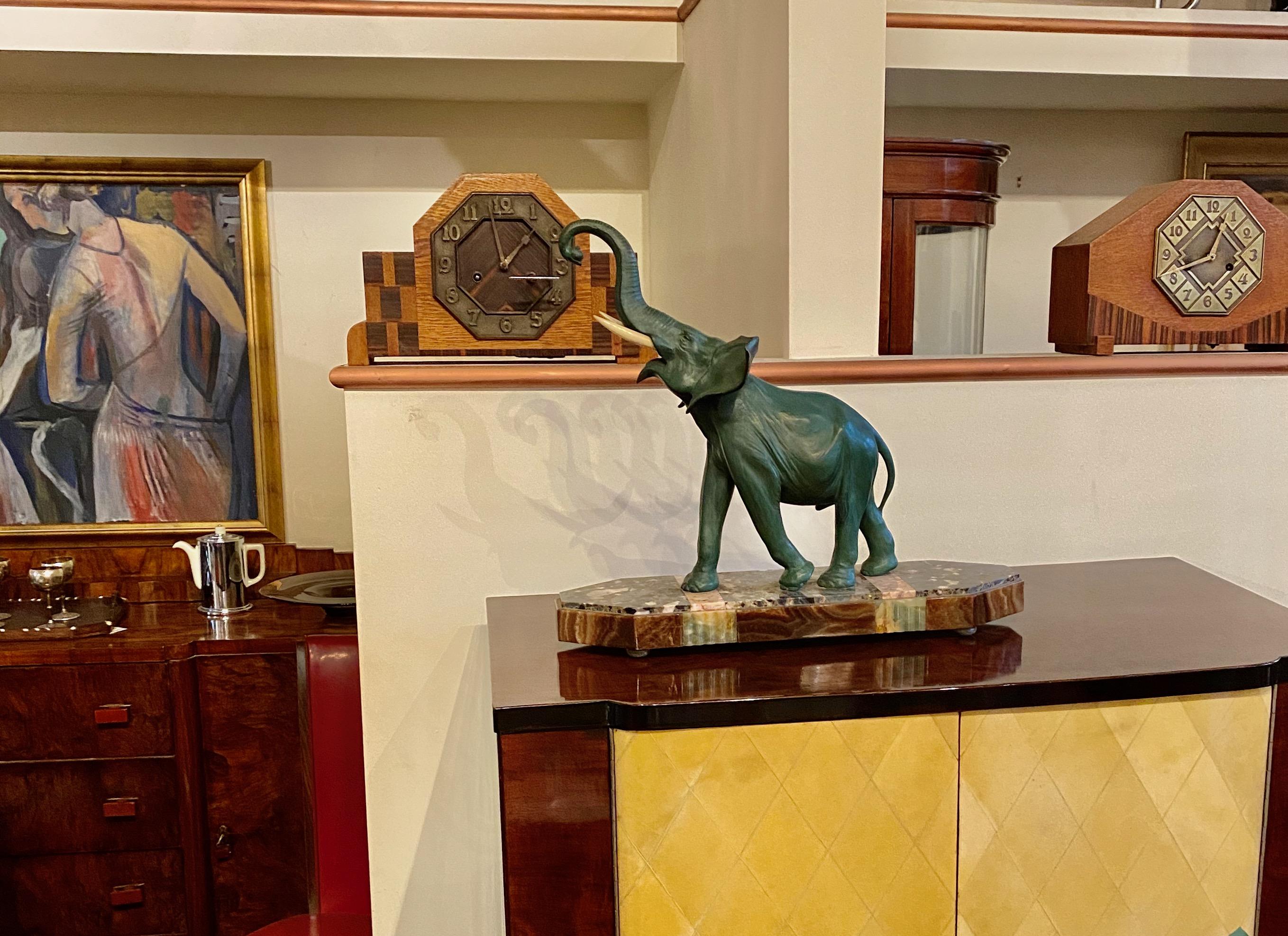 Art Deco elephant sculpture on marble stylized base. Spelter metal with ivoroid ( synthetic) tusks, in the lucky position of going upward. This is a great piece, showing style and movement, the best way to preserve the beauty of these magnificent