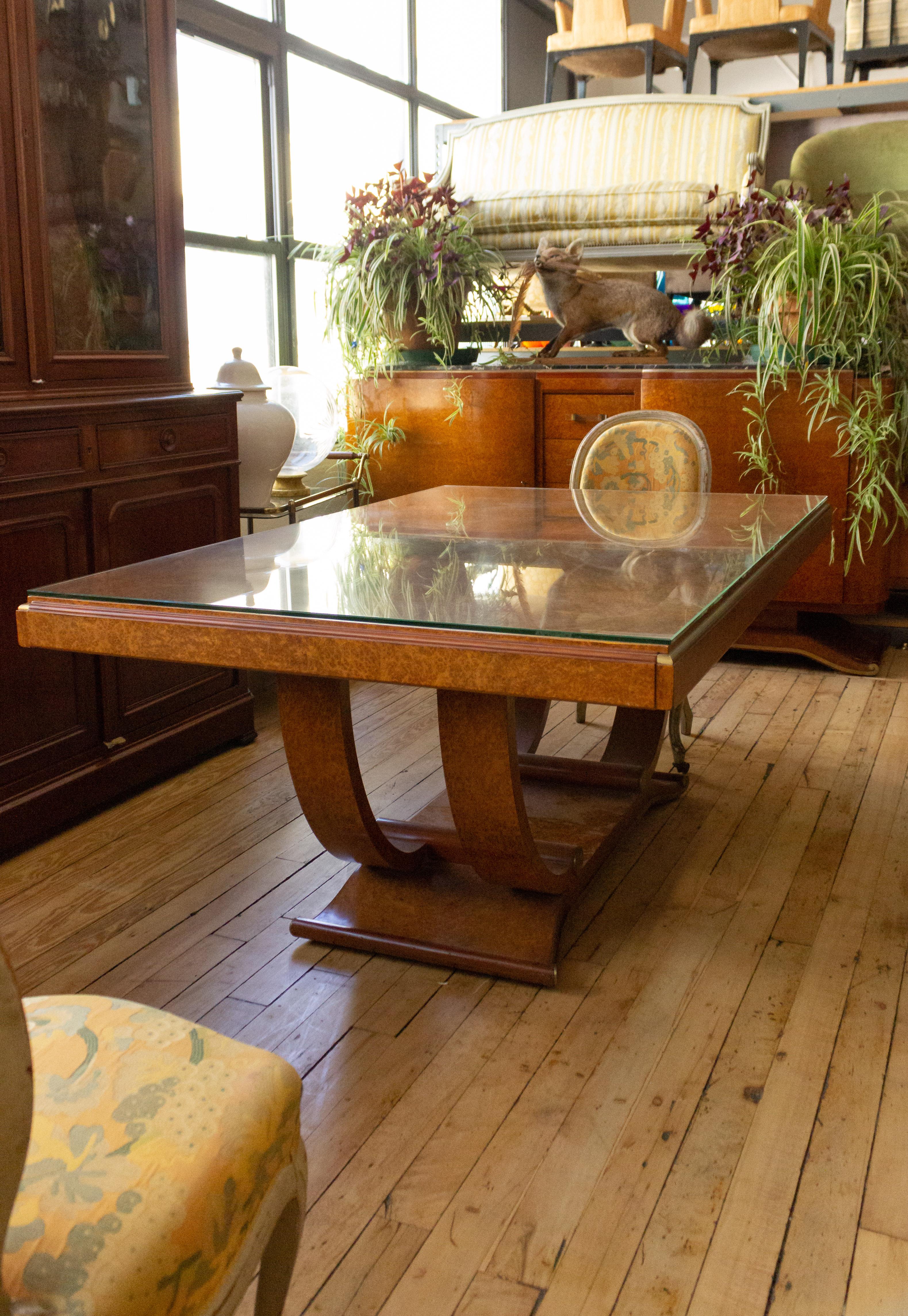 Art Deco dining table in elmwood burl with brass detail and protective glass.