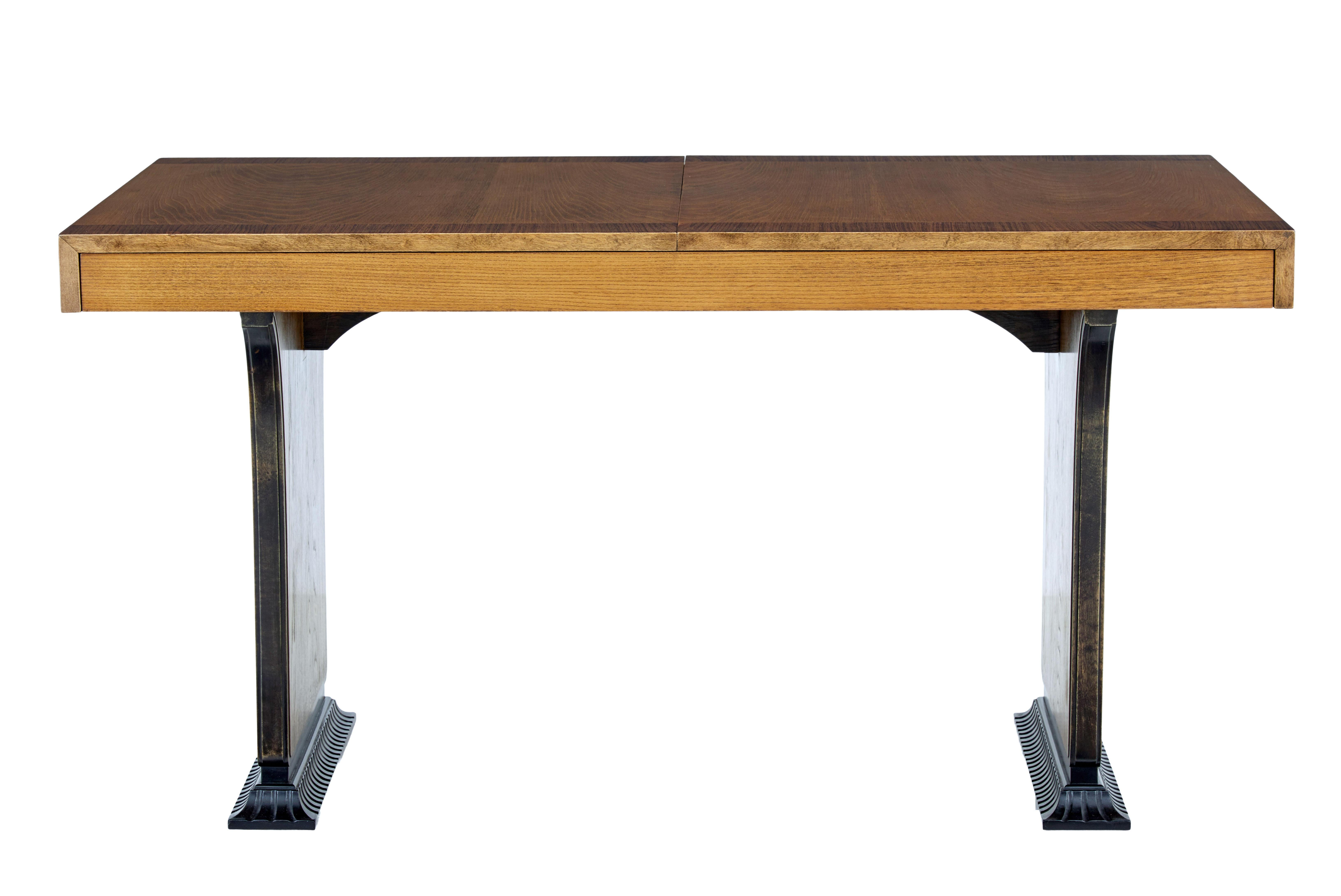 Beautiful inlaid table by Swedish designer Erik Chambert circa 1930.

Formerly an extending dining table, without the leaves this table is perfect for a desk.

Rectangular elm top with rosewood crossbanded edge. Standing on a pair of shaped