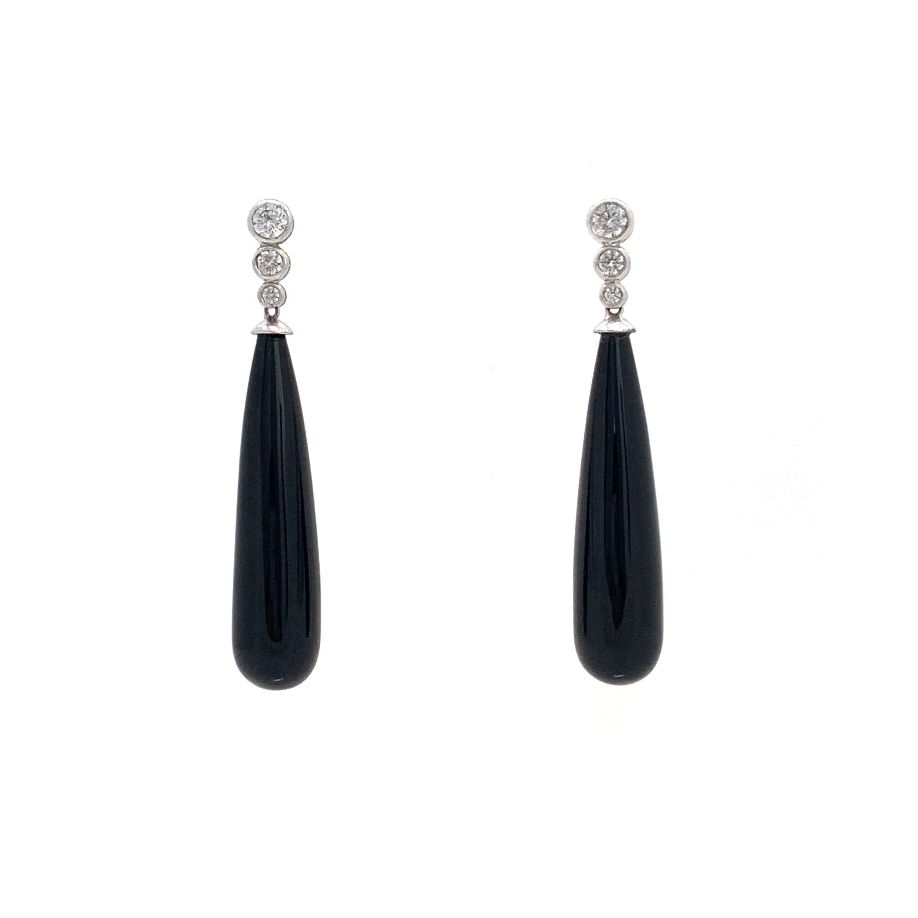 Art Deco style elongate teardrop Onyx earrings. The earrings features teardrop black onyx and faux diamond cubic zirconia adorned in art deco style - with platinum rhodium plated over sterling silver. Straight post with large friction back for
