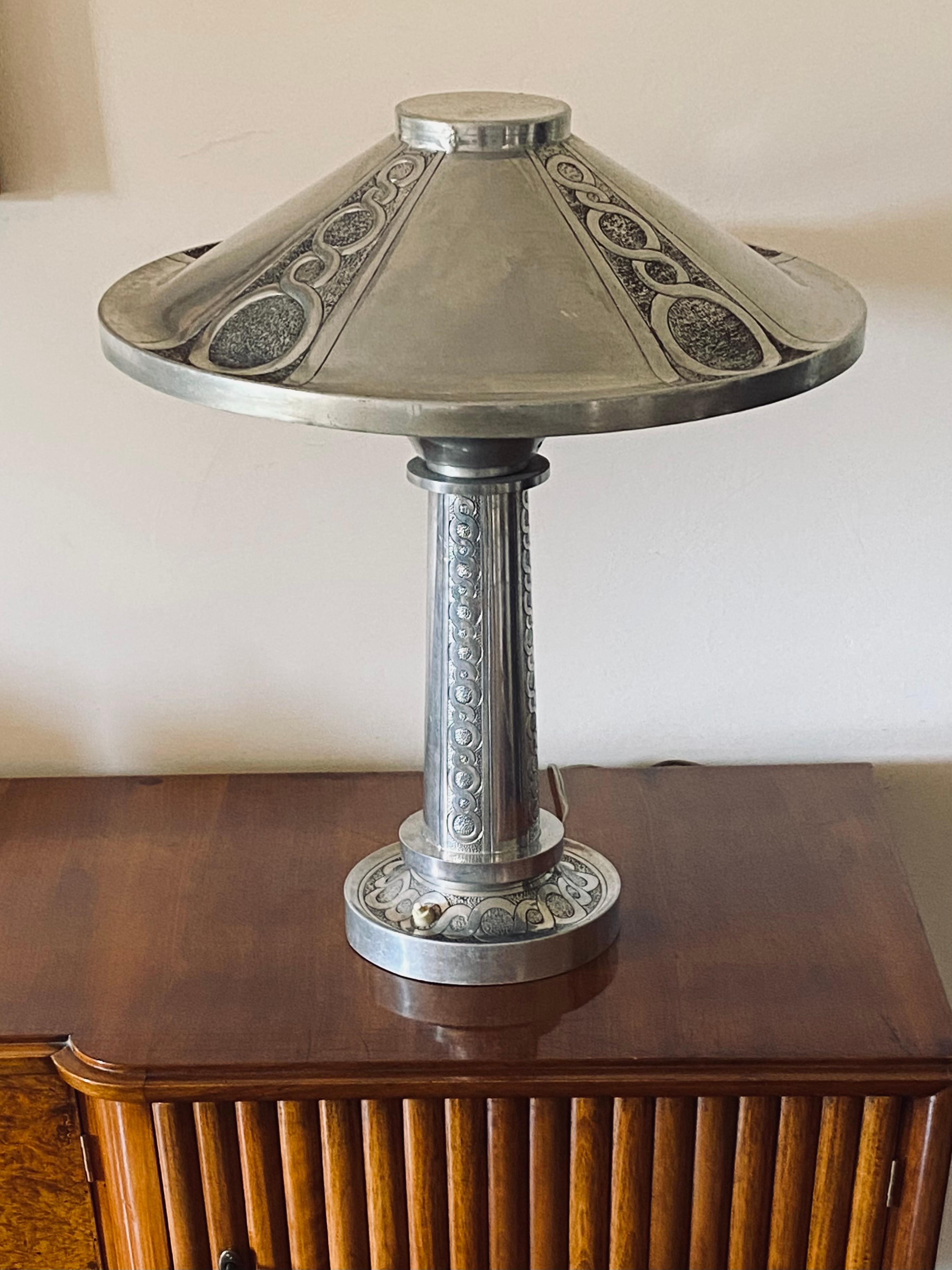 Art Deco monumental embossed Table Lamp

France, ca. 1920s

Highly handcraft decorated. All original lamp base and shade with embossed details.

H 60 cm

Diam. 50 cm

Conditions: excellent consistent with age and use. In working conditions