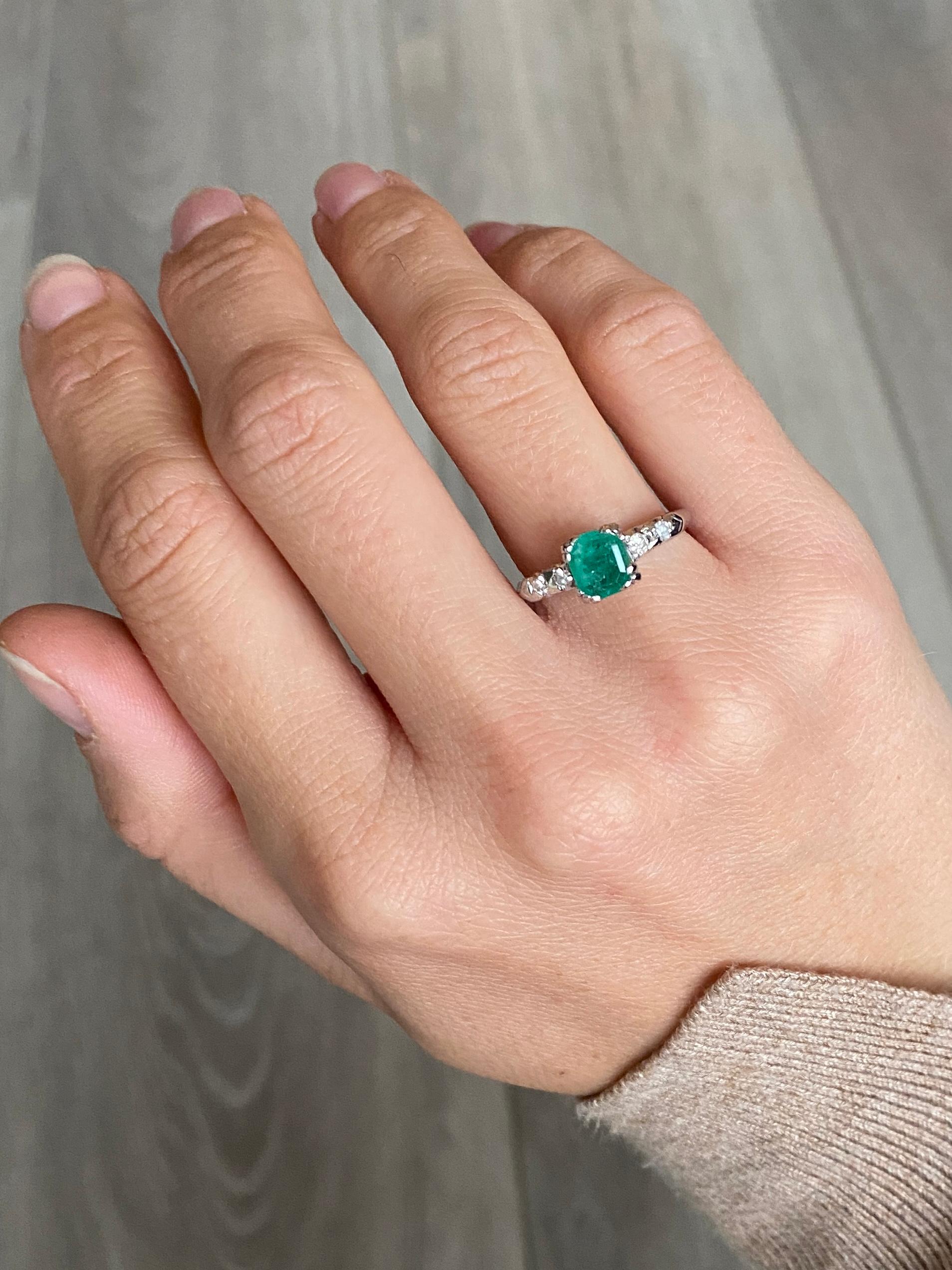 emerald ring with diamonds either side