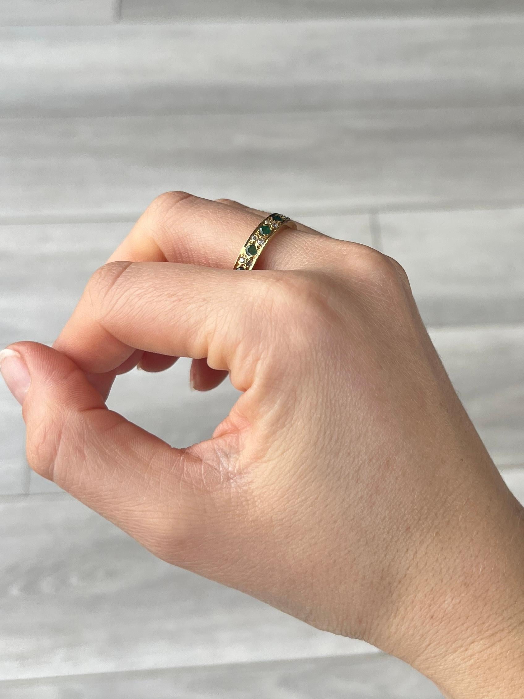 A stunning Art Deco eternity band ring fully set with emeralds and diamonds. Alternating round cut green emeralds are set between pairs of round-cut white diamond all around this wonderful ring. Modelled in 18 carat gold. Emerald total 1.2carat,