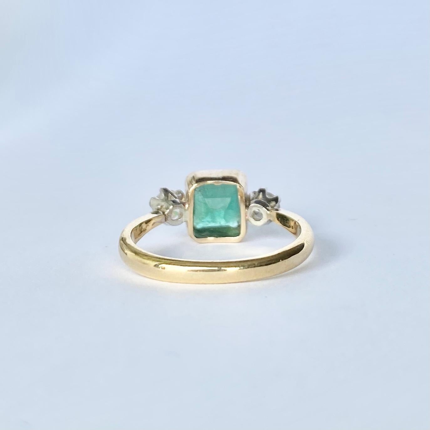 The central emerald is so bright and beautiful and measures approx 1.05ct. Sat either side it are two bright shimmering old European cut diamonds each measuring 20pts. The ring is modelled in 18ct gold and the diamonds are set in platinum. 

Ring