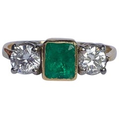 Art Deco Emerald and Diamond 18 Carat Gold Three-Stone Ring