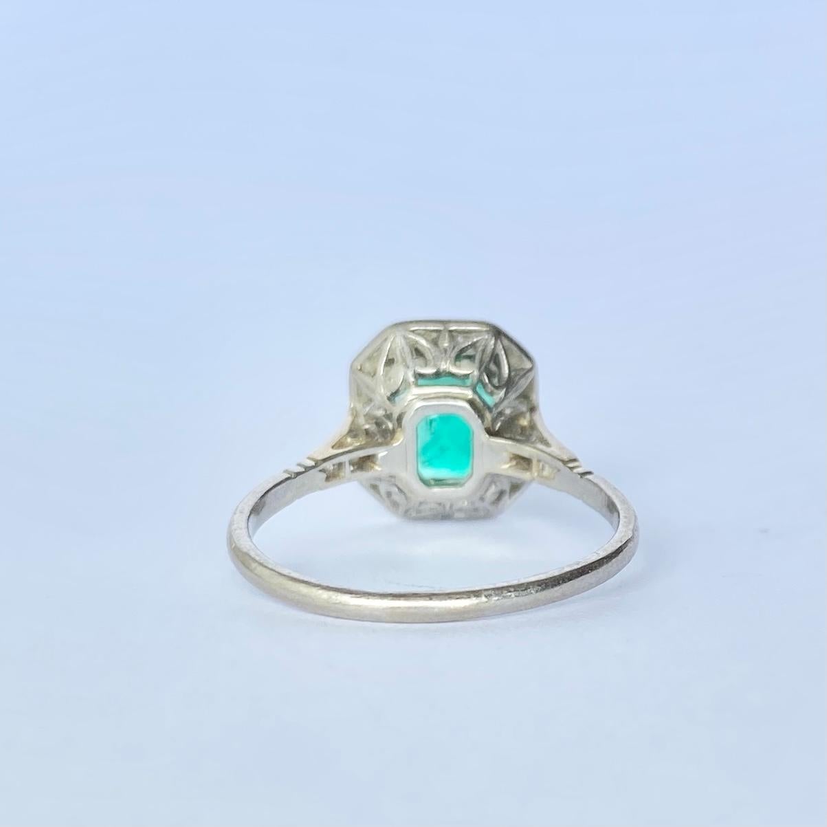 A superb antique Art Deco panel ring centrally set with a classic emerald-cut 75pt green emerald. The emerald is bordered by shimmering white diamonds totalling aprox 40pts. 

Ring Size: L 1/2 or 6
Panel Dimensions: 11x9.5mm

Weight: 3.1g
