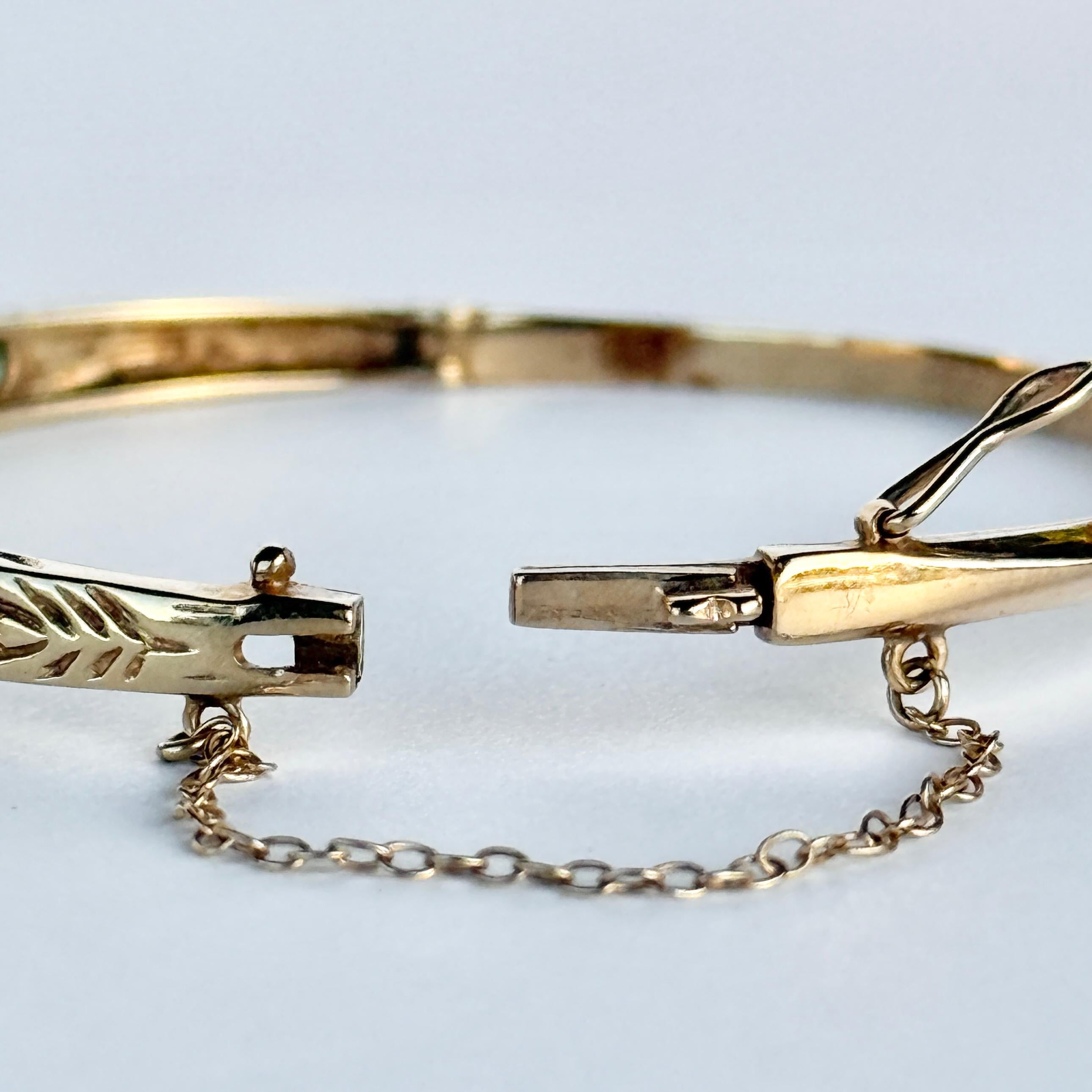 The detailed bangle holds eleven emeralds and diamond points in-between. The detail on this bangle is stunning and so intricate. The emeralds total approx 2ct Modelled in 9ct gold. 

Inner Diameter: 5.8cm
Inner Circumference: 16.5cm
Bangle Width: