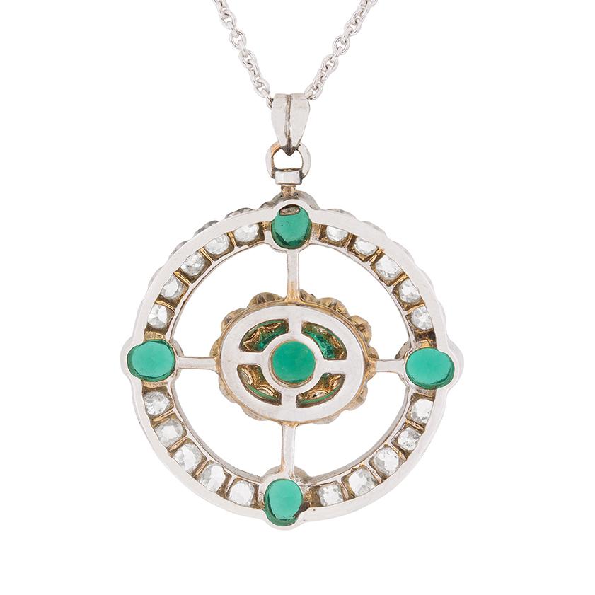 This wonderful pendant consists of a central claw set emerald, with emeralds then set at each cardinal point. The centre luscious green emerald weighs 0.50 carat, whilst the remaining four are 0.25 carat each. The centre has a scalloped halo of
