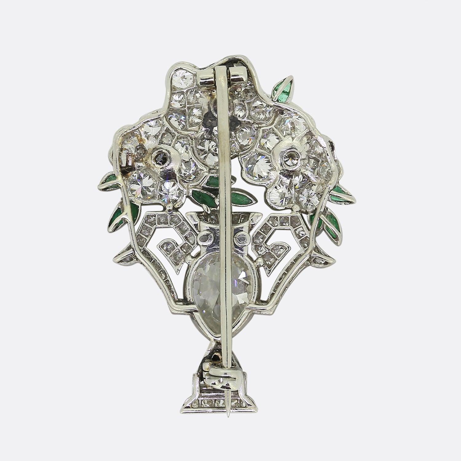 Here we have a very special flower brooch crafted at a time when the Art Deco style was at the height of design. The centre of the piece showcases an old pear cut diamond possessing a high colour and clarity. This focal stone is surrounded by single