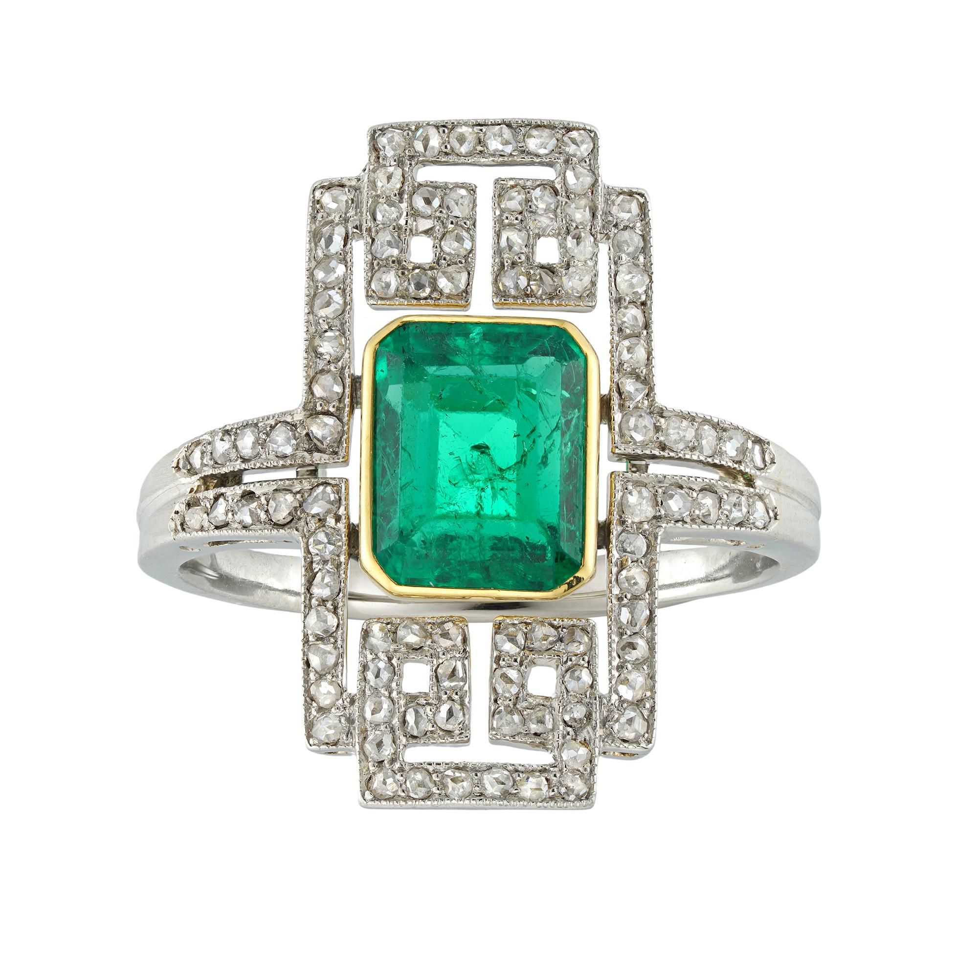 An Art Deco emerald and diamond plaque ring attributed to Janesich, the emerald-cut emerald estimated to weigh 1.8 carats, accompanied by GCS laboratory report, stating to be of Colombian origin, with minor enhancement, rubover-set in yellow gold to