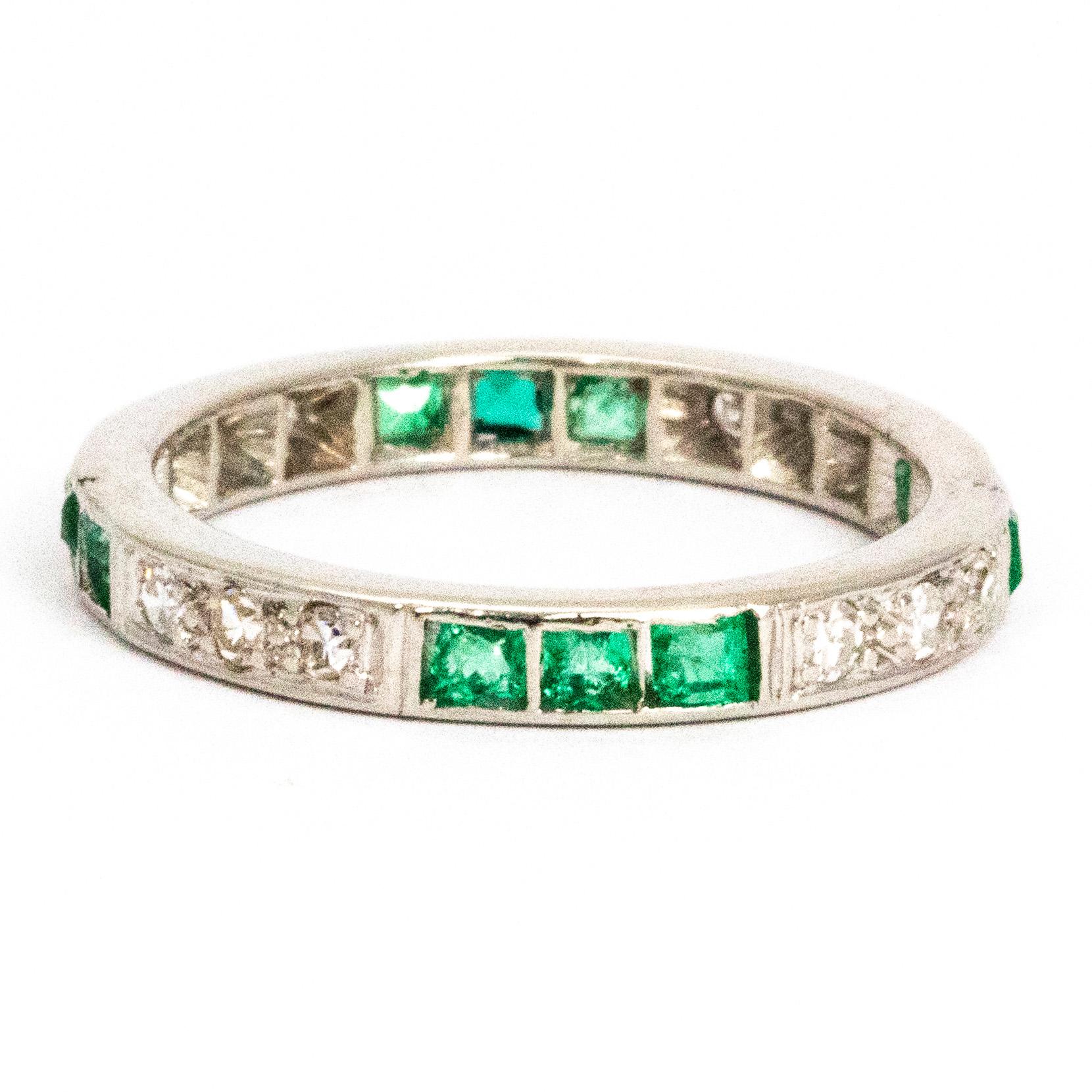 This gorgeous emerald and diamond eternity is a real stunner. The round cut diamonds and square cut emeralds sit in sparkling trios within the platinum band. Each diamond measures 5pts and each emerald measures 10pts.

Ring Size: O or 7
Band Width: