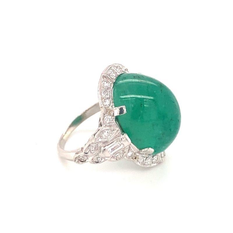 One Art Deco emerald and diamond platinum ring featuring one oval cabochon cut emerald weighing 15 ct. Enhanced by 30 single cut and baguette diamonds totaling 0.75 ct. Art Deco period piece, circa 1930s.

Lovely, statement, intricate.

Additional