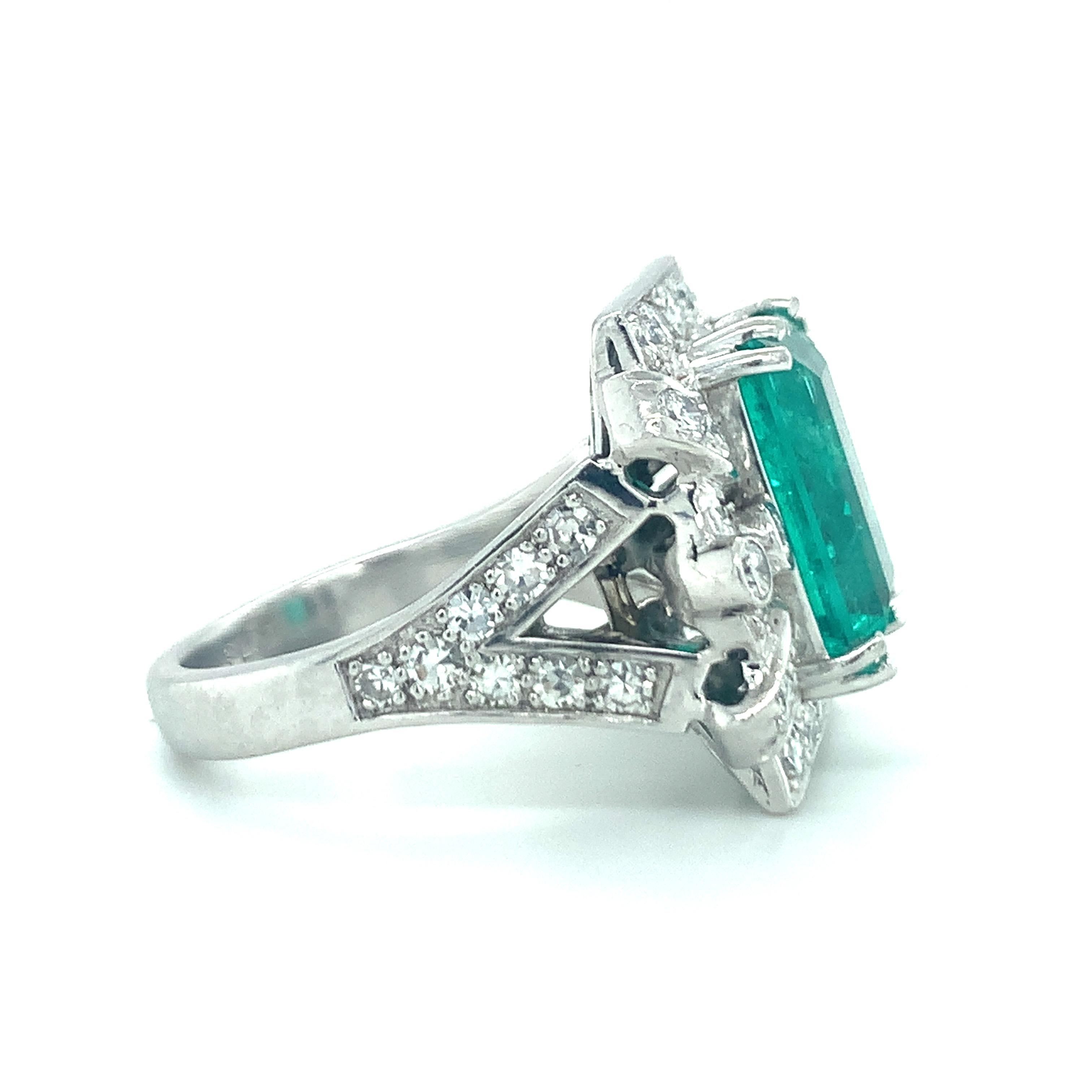 One Art Deco emerald and diamond platinum ring centering one prong and bezel set, emerald cut emerald weighing 5.50 ct. with GIA Report stating Colombian origin. The ring is accented by 42 round brilliant and single round cut diamonds weighing 1.20