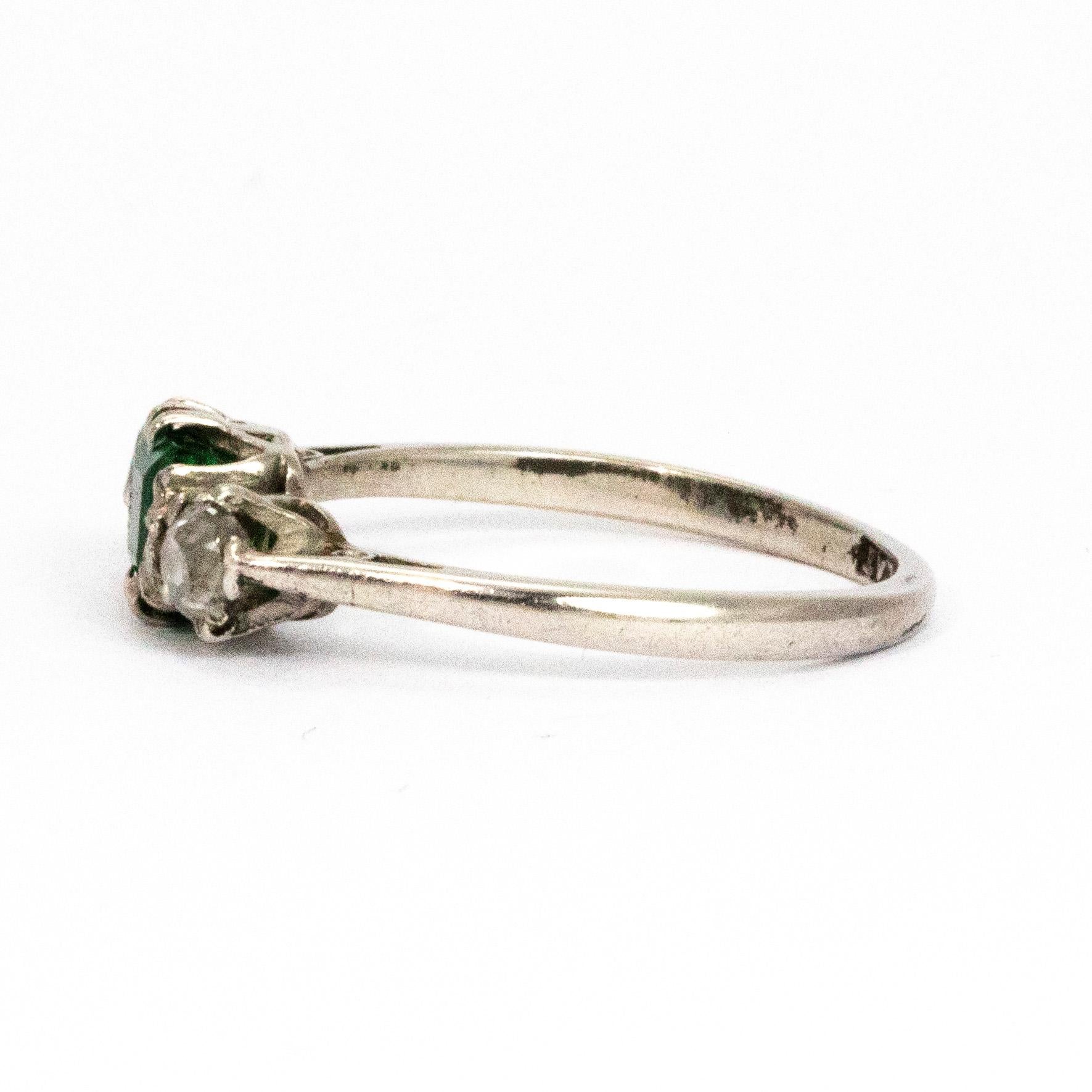The emerald in the centre of this trio of stunning stones measures 50pts and the shimmering round cut diamonds that sit either side measure 20pts each. All modelled in platinum.

Ring Size: M or 6 1/4