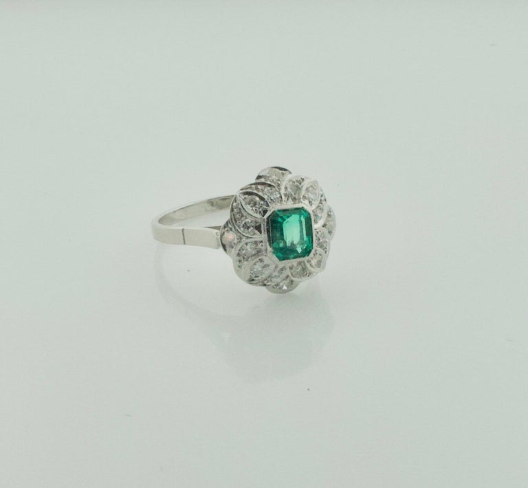 Art Deco Emerald and Diamond Ring in Platinum
One Emerald Cut Emerald Weighing .75 carats approximately. [Very Bright]
16 Round Brilliant Cut Diamonds Weighing .30 Carats Approximately [GH VVS-SI]