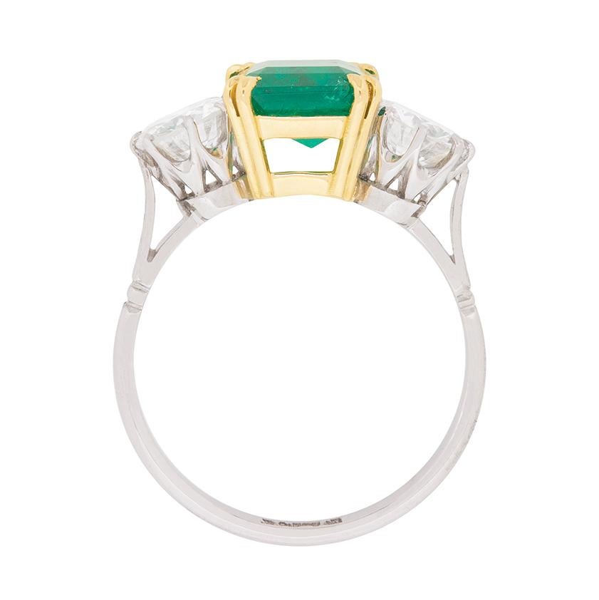 A breath-taking ring from the 1930s. In the centre is a rich green Emerald, which is expertly set within a handmade 18 carat yellow gold collet. The gemstone weighs 1.90 carat and has been certified by the well respected company The Gem and Pearl