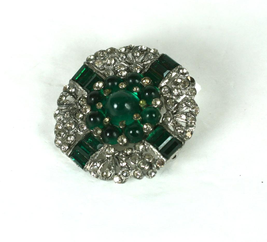 Art Deco Emerald Cab Brooch from the 1930's. High quality manufacture with channel set emerald paste baguettes and cabochons. Likely unsigned Trifari.
1.4