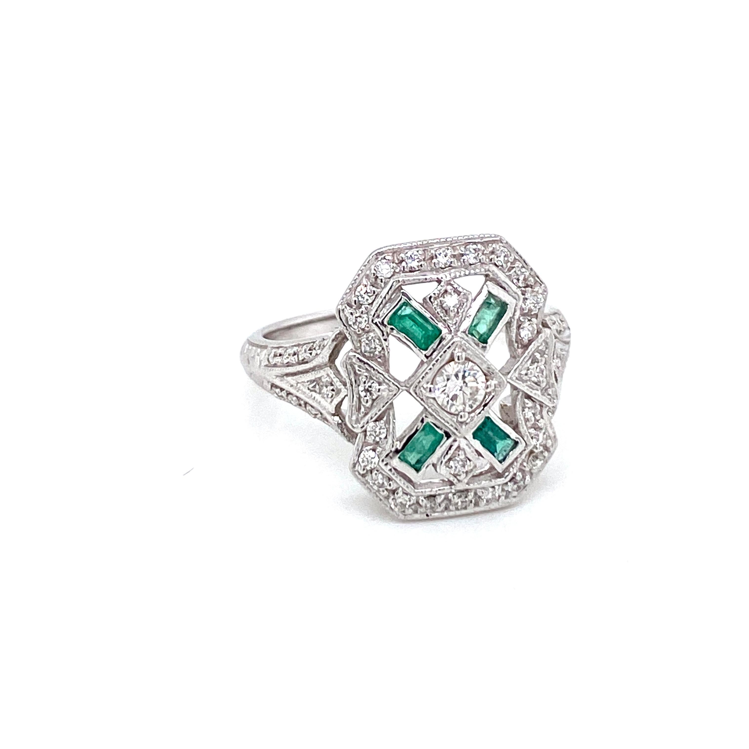 Beautiful Gold handmade Art Deco style ring.
It is set in 14k white Gold featuring Natural Emeralds baguette cut and sparkling Round brilliant cut diamonds, total weight 0,60 ct. G color VVS1 clarity, 
Circa 1980

CONDITION: Pre-owned - Excellent
