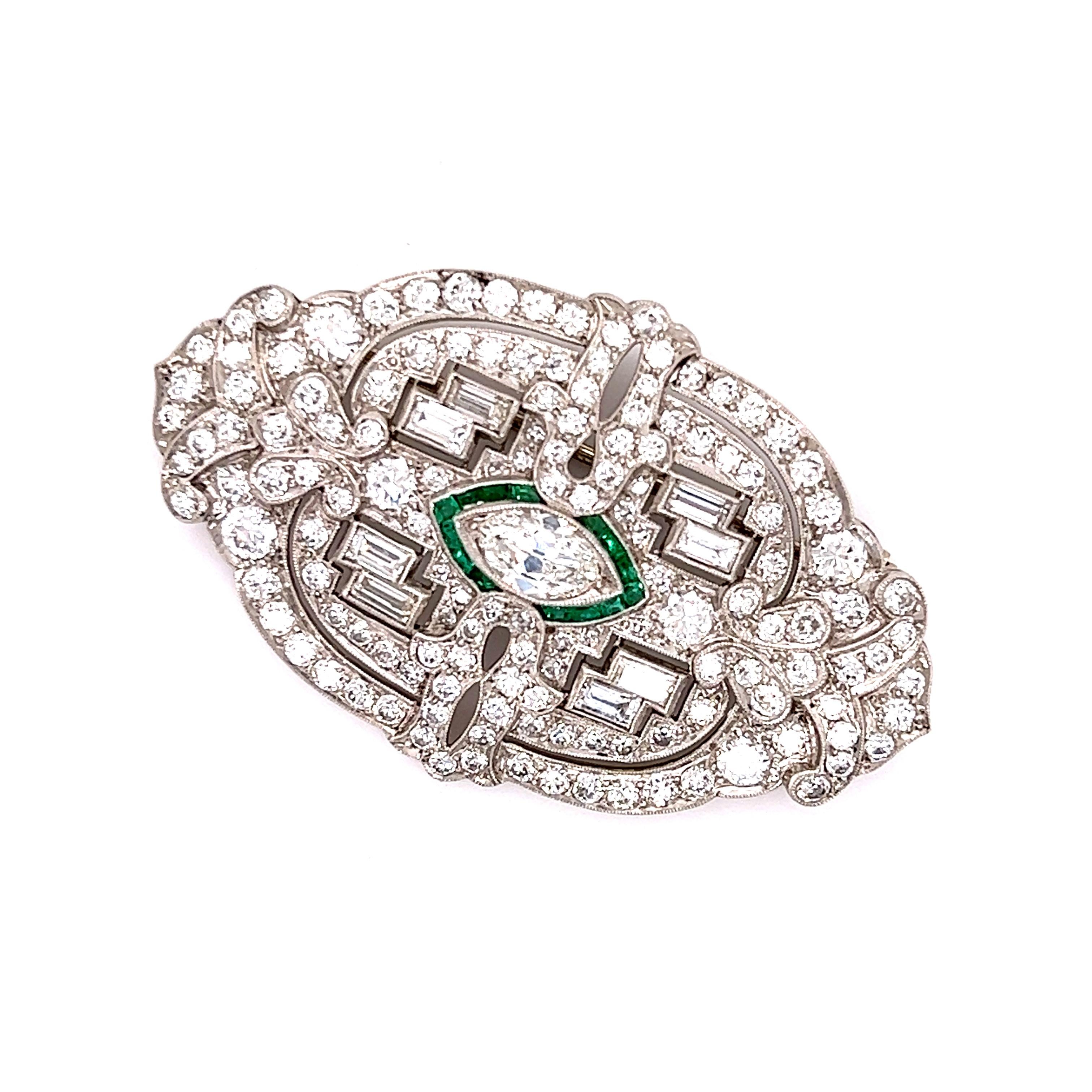 Exquisite detail is seen on this Art Deco treasure. Crafted in platinum this brooch is sure to stand out whenever worn.  Highlighting the brooch is one east/west set old European cut marquise shaped diamond. The diamond is surrounded by emerald
