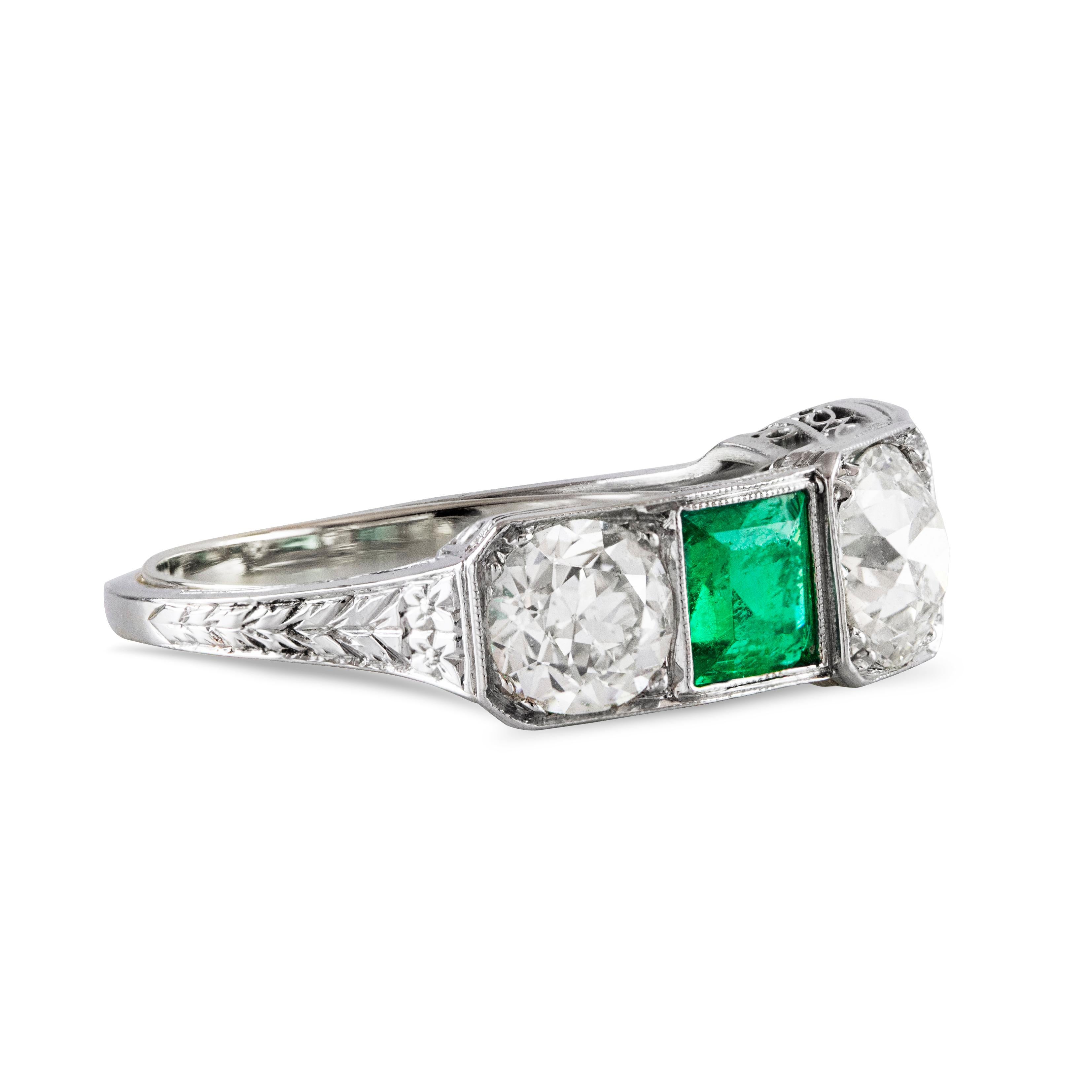 This gorgeous vintage ring features three Old European cut diamonds weighing 2.15 carat total, elegantly alternates with square cut green emerald in between weighing 0.97 carats total. Made in Platinum with beaded edges. 