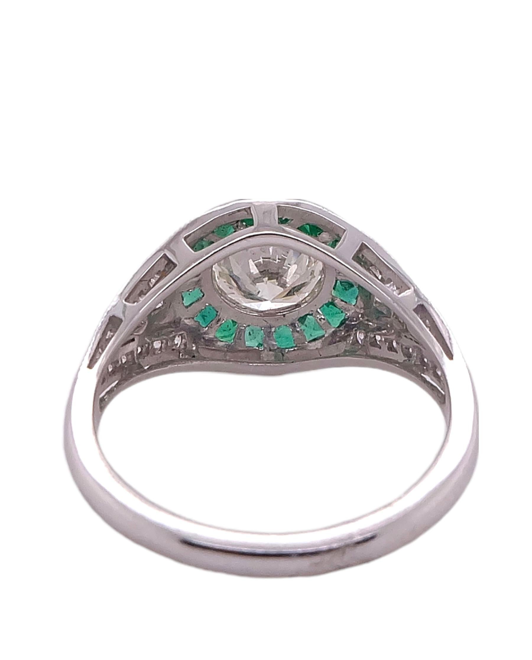 Sophia D Art Deco designed platinum ring that features a round cut center stone ring that weighs 1.03 carat surrounded with emeralds that weigh .35 carats and diamonds that weigh 0.25 carats. 

Available for resizing,

Sophia D by Joseph Dardashti