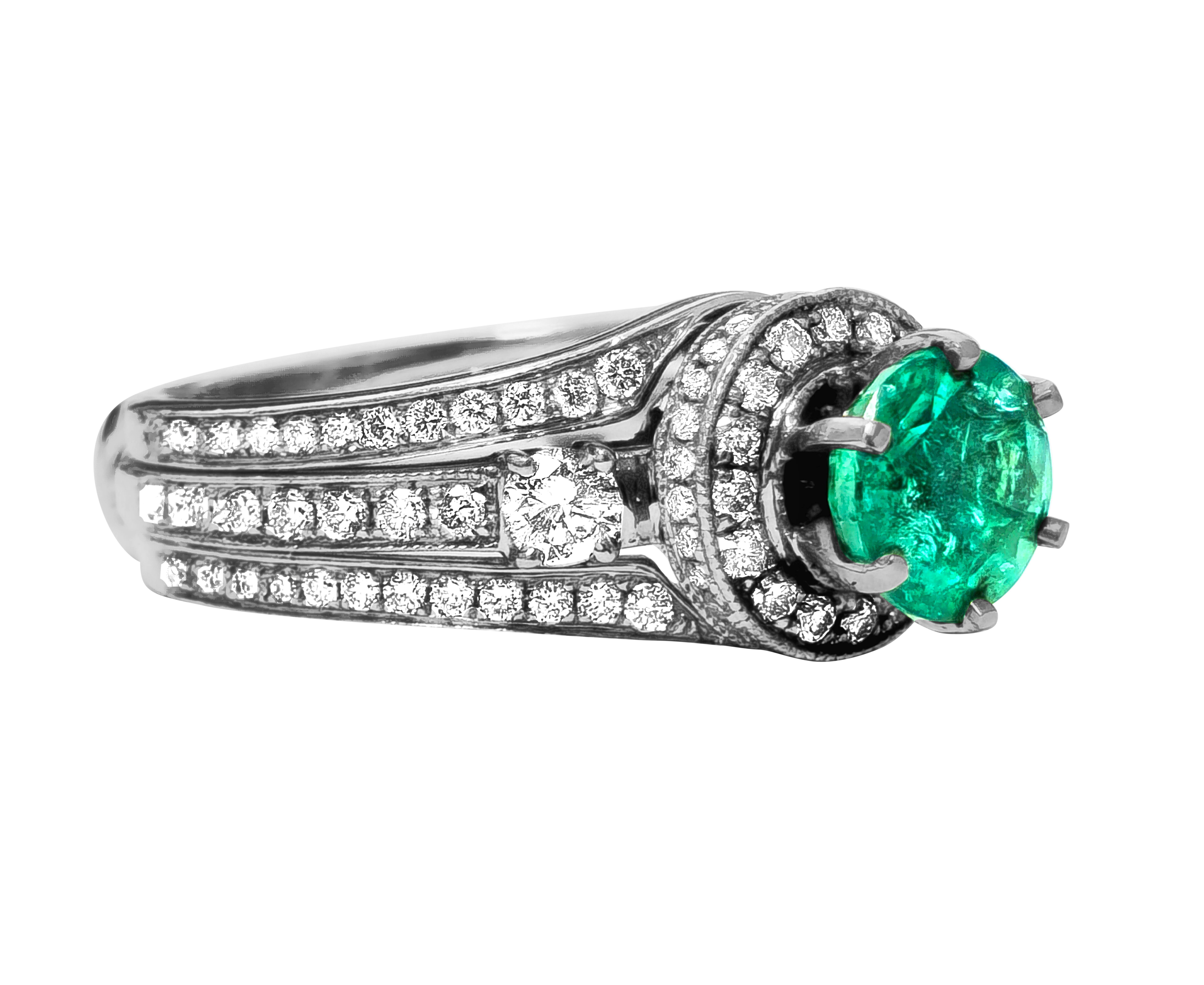 Presenting this exquisite emerald and diamond ring crafted from 14k white gold, featuring a stunning 1.25 carat round natural earth-mined emerald set in prongs, accompanied by 1.10 carats of round brilliant-cut side diamonds boasting VS-SI clarity