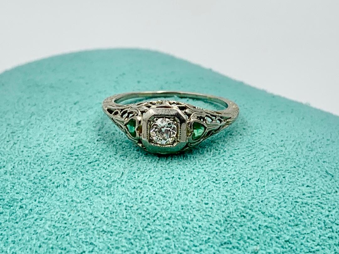 This is a stunning Antique Art Deco - Edwardian Heart Motif Diamond and Emerald Wedding Ring Engagement Stacking Ring set with a gorgeous .25 Carat Old European Cut Diamond of brilliant white F color!  On either side of the Diamond are two