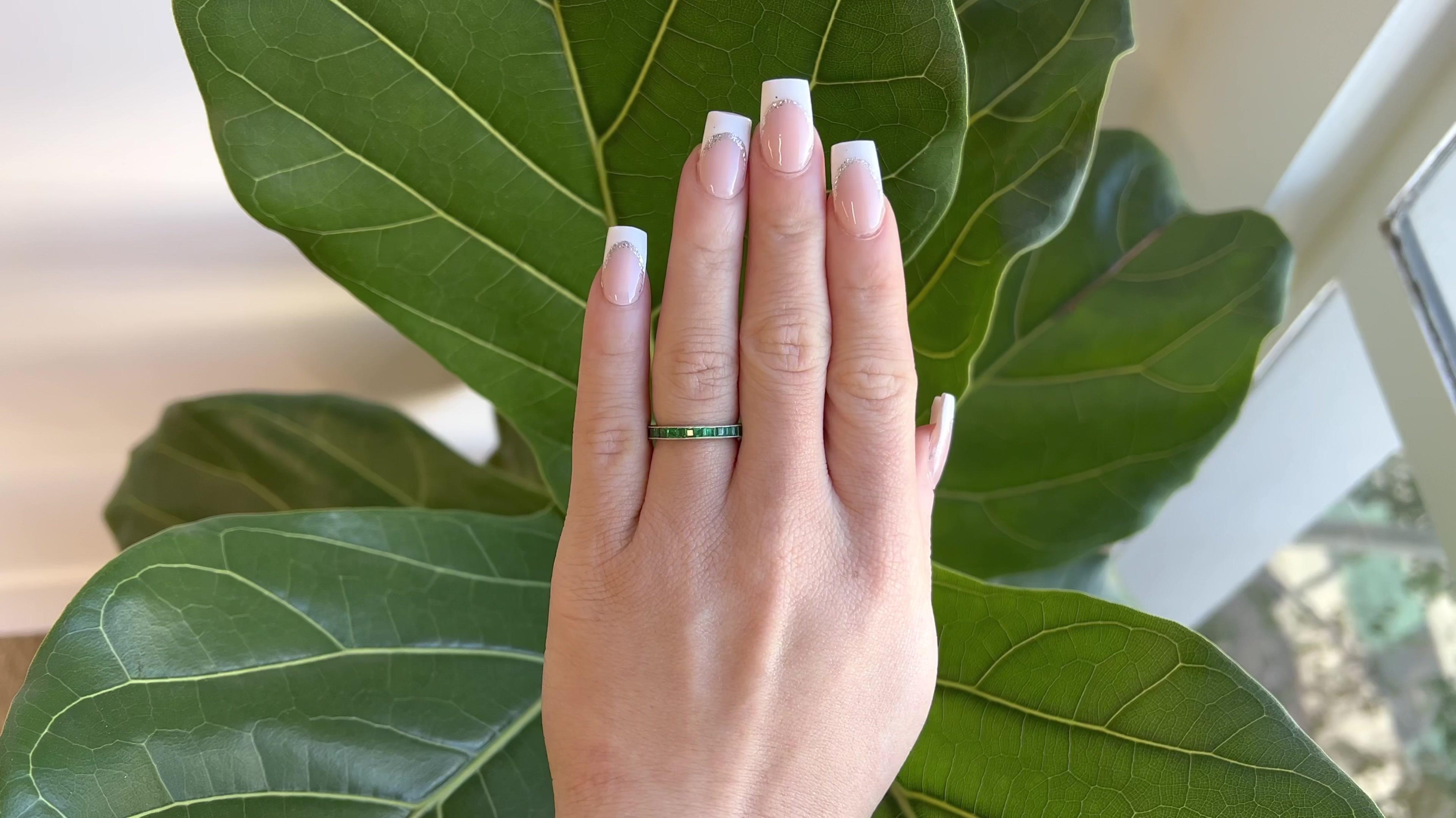 One Art Deco Emerald Platinum Engraved Eternity Band. Featuring 30 calibré cut emeralds with a total weight of approximately 2.00 carats. Crafted in platinum. Circa 1920s. The ring is size 6 1/4. 

About this Item: A finely made ring with