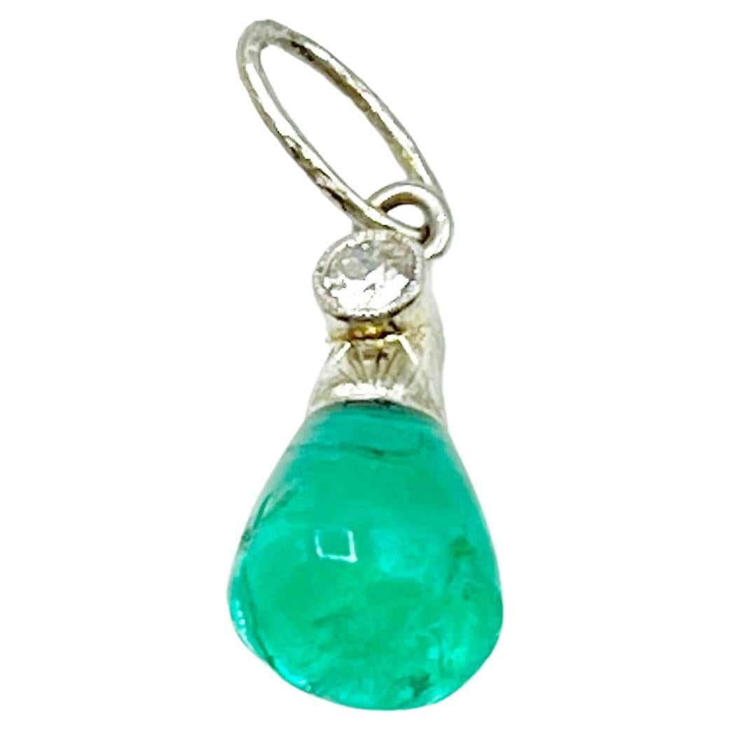 This yummy emerald in the shape of a teardrop has a beautiful green translucency. The setting is 14 Karat white gold with a bezel set diamond (0 .10 carat) and delicate etching. This pendant can easily be worn every day as your favorite center piece