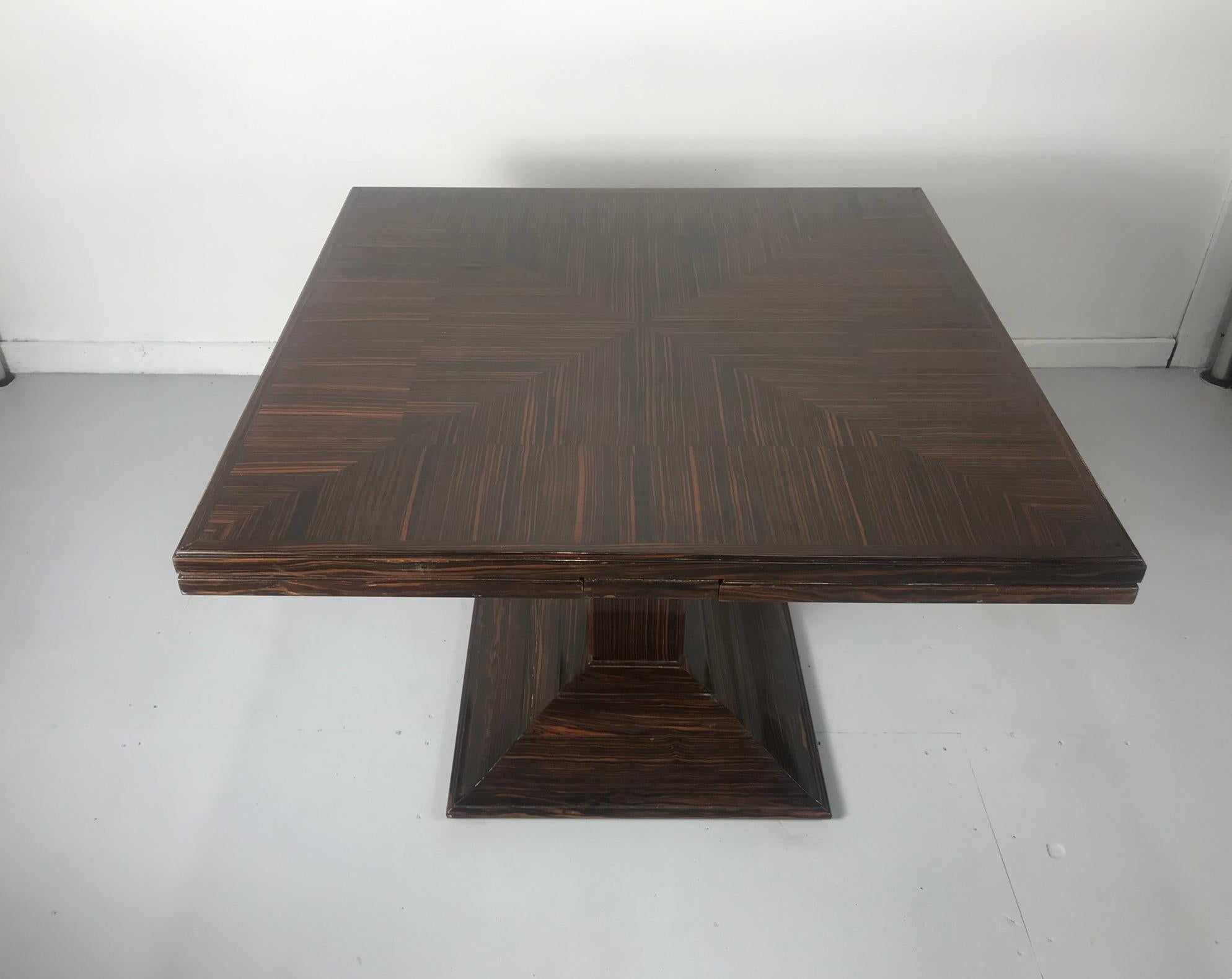 Beautiful and rare example, Art Deco extension table, model 1315 NR, circa 1929, Stampted Ruhlmann and a, stunning figured, richly grained Macassar ebony wood, edge veneer loss.

Measures: Closed: Height 29 5/8, width 41 3/8, depth 29