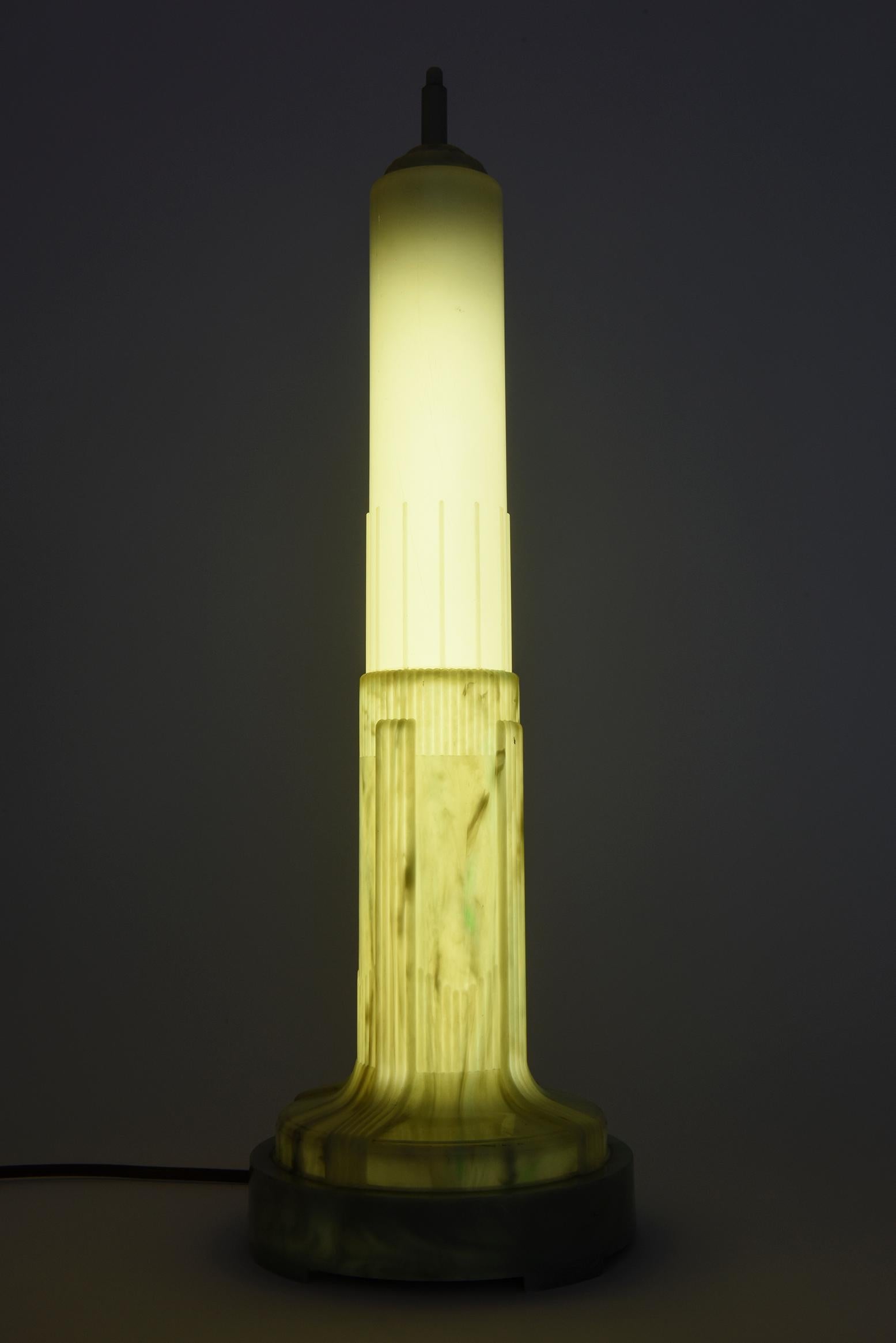 Cream and green marbleized celluloid art deco lamp modeled after the beacon on the Empire State Building, with fluorescent tube, made in America, 1938.


    