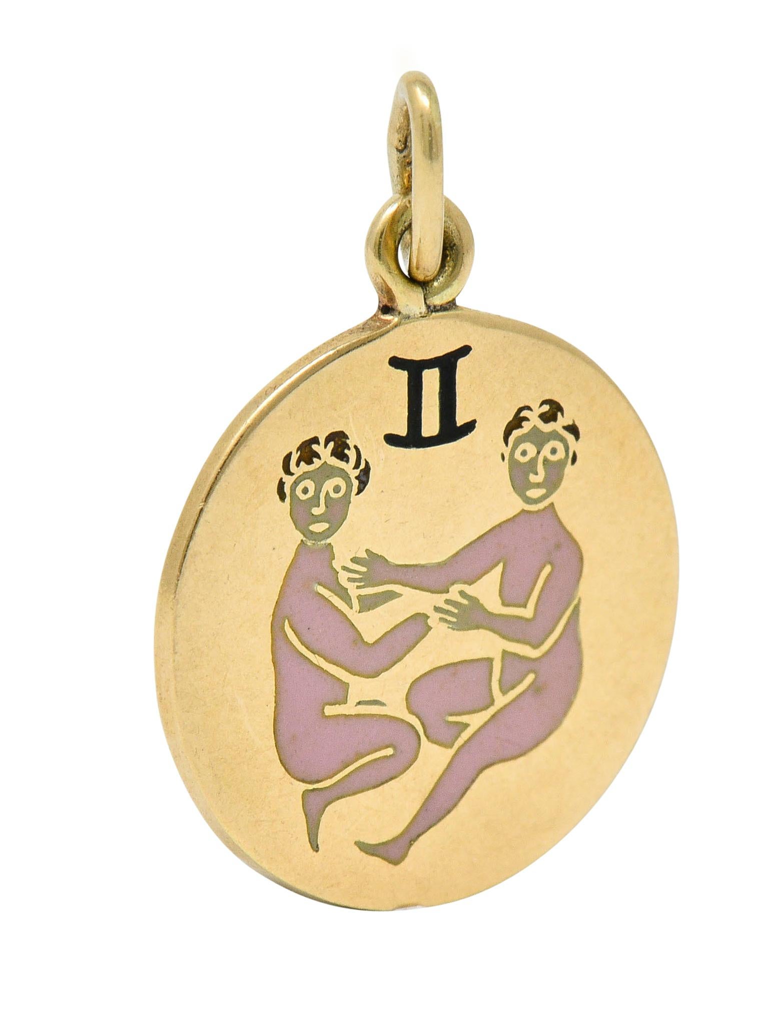 Circular charm depicts two boyish figures seated below the Gemini motif

With pink and black enamel details; exhibiting no loss

Back is inscribed with a dated inscription

Stamped 14K for 14 karat gold

Maker's mark for Richardson Manufacturing