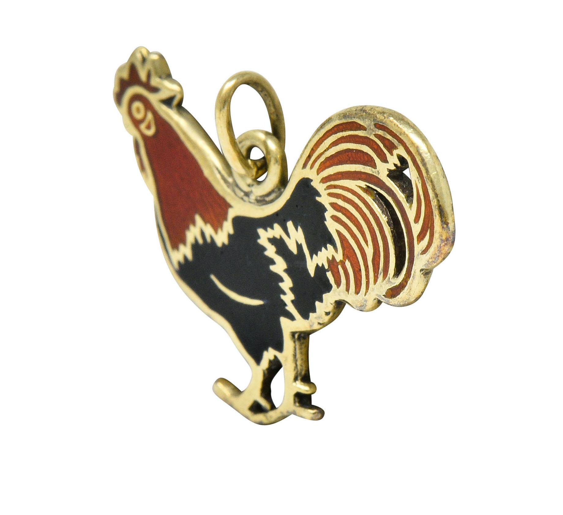 Designed as a strutting rooster with a full plume of tail feathers

Glossed with black and red enamel, exhibiting no loss

Depiction is featured on both sides

Tested as 14 karat gold

Circa: 1930

Measures: 3/4 x 5/8 inch

Total weight: 1.3