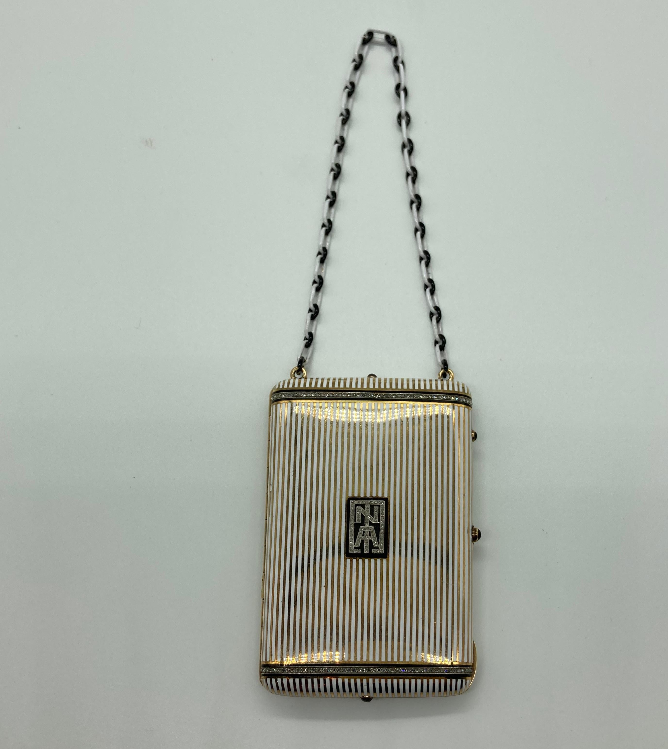 An impressive Art Deco cigarette case with enamel and diamonds, suspended from an enameled chain. Circa 1920s.