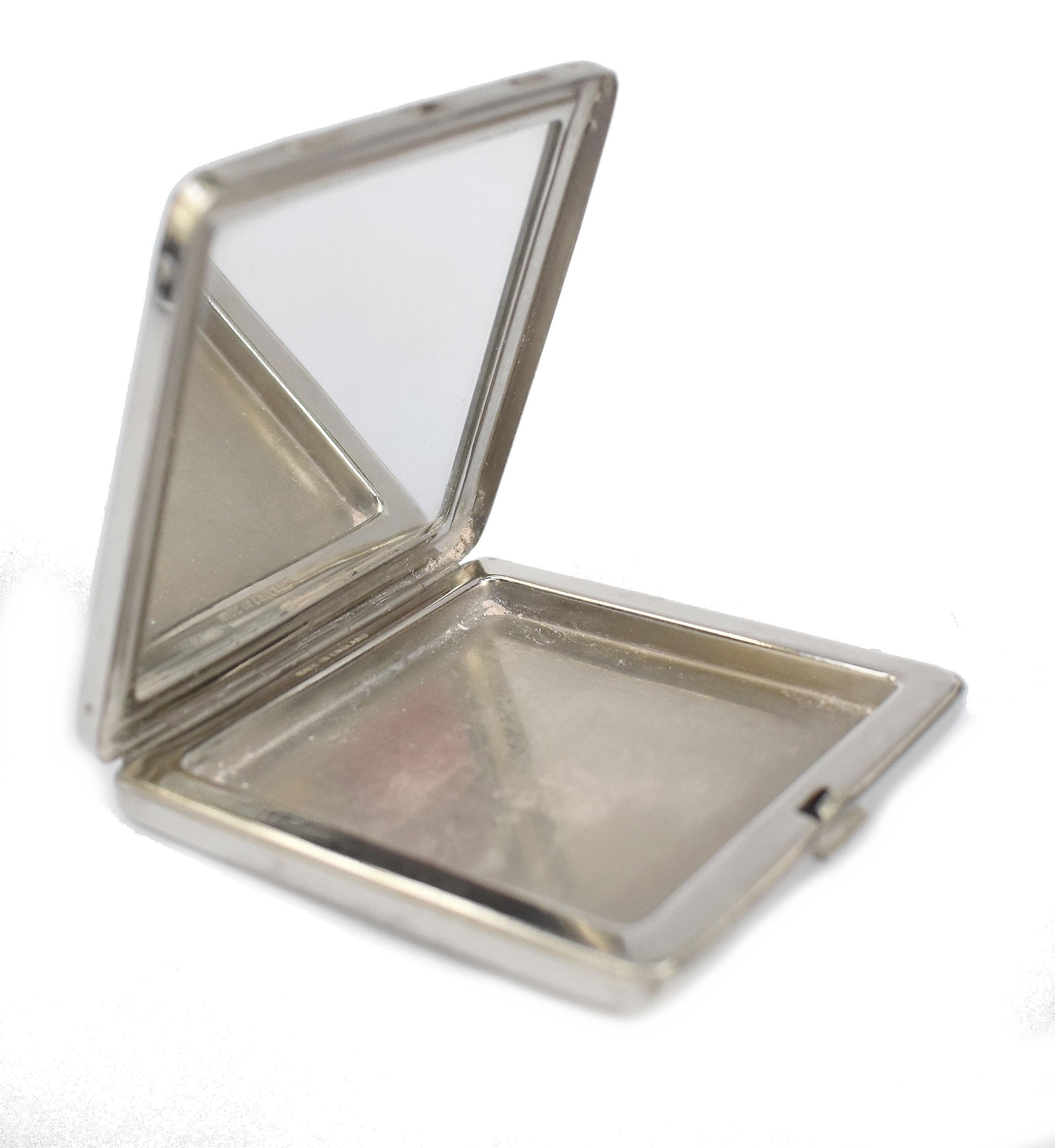 Offered for your consideration is this beautifully stylish Art Deco ladies powder compact by Dubarry . The case is made of chromium metal with machine turned pattern on the reverse with Dubarry name on the base. The lid is jet black enamel with