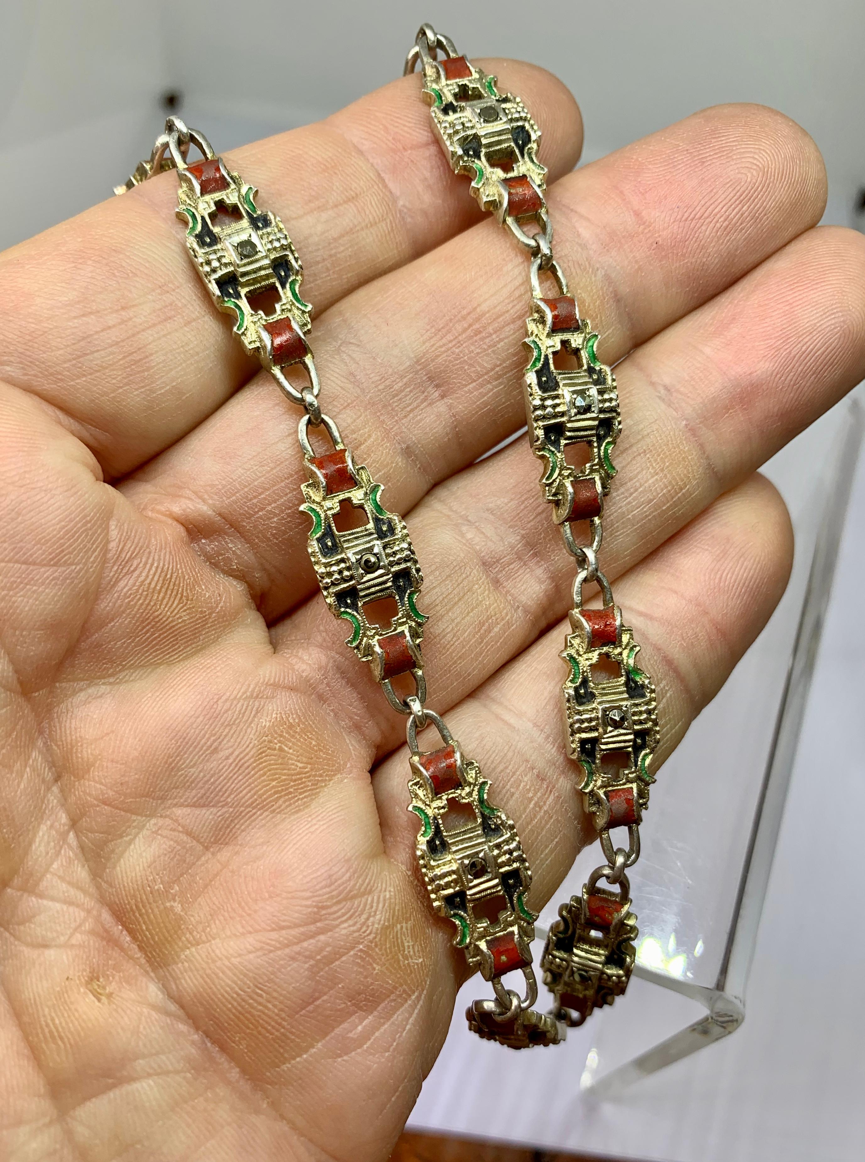 THIS IS A RARE MUSEUM QUALITY ART DECO CHAIN NECKLACE WITH THE MOST GORGEOUS LINKS IN SILVER AND ADORNED WITH RED GREEN AND BLACK ENAMEL AND MARCASITES OF GREAT BEAUTY.  THE NECKLACE DATING TO CIRCA 1920.
It is very rare to find antique Art Deco