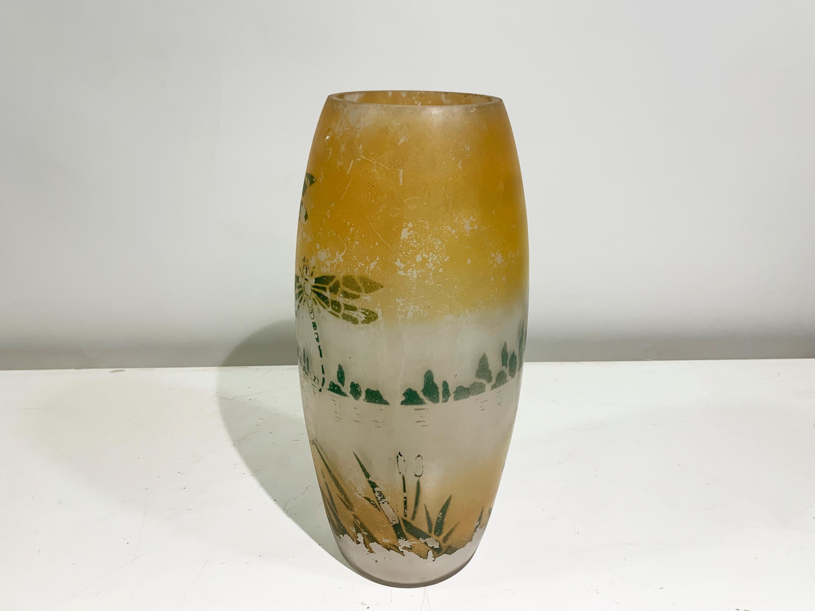 The vase is decorated with a delicate, nature-inspired motif. The upper portion of the vase features a warm, amber-colored gradient that fades into a frosted, semi-transparent white towards the middle and bottom. The main decorative elements are