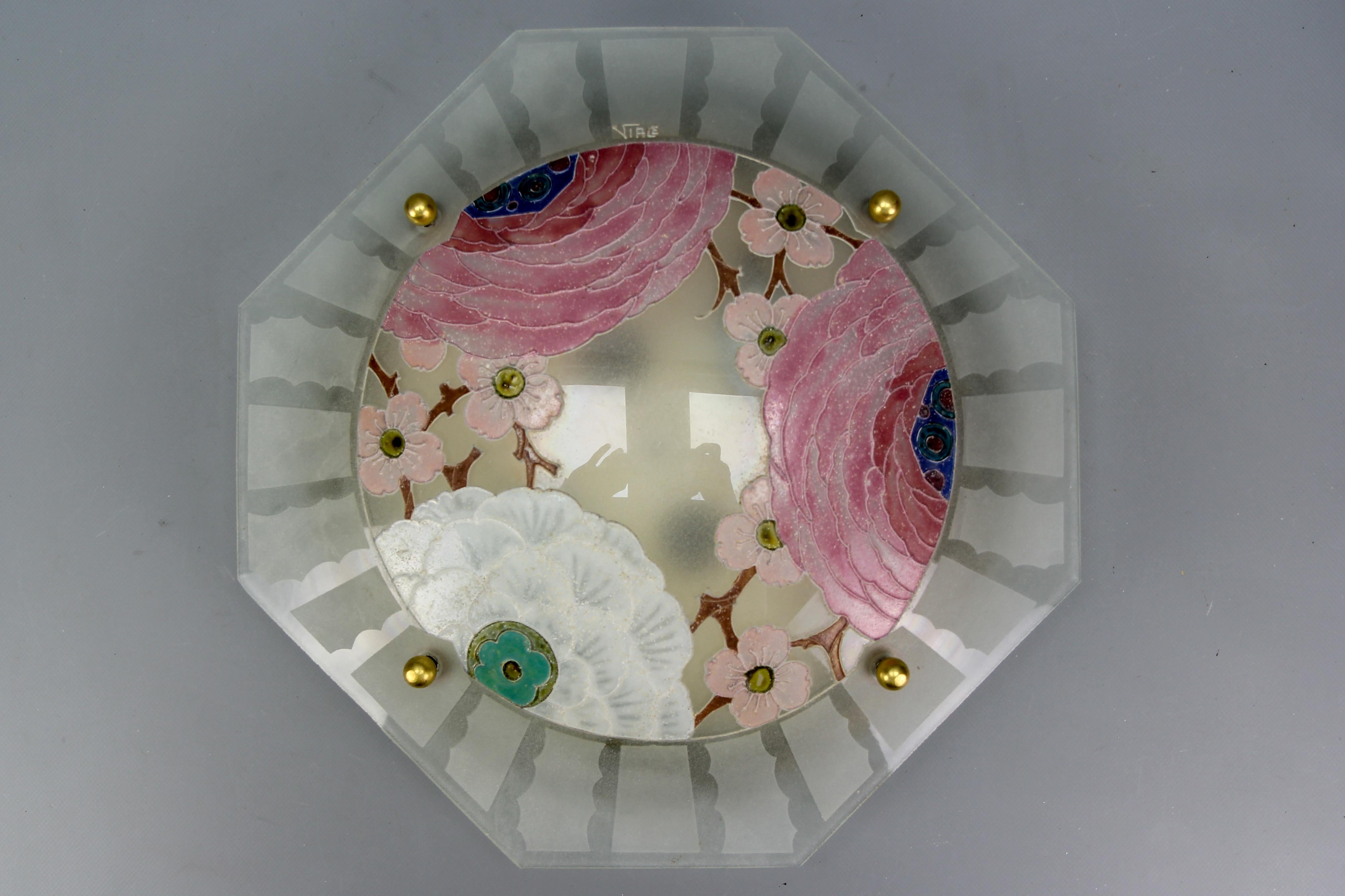 French Art Deco enameled glass flush mount with pastel color flowers signed Viale, circa the 1930s.
This adorable flush mount features a beautiful octagonal frosted glass lampshade with stylized Art Deco enamel hand-painted flowers and apple