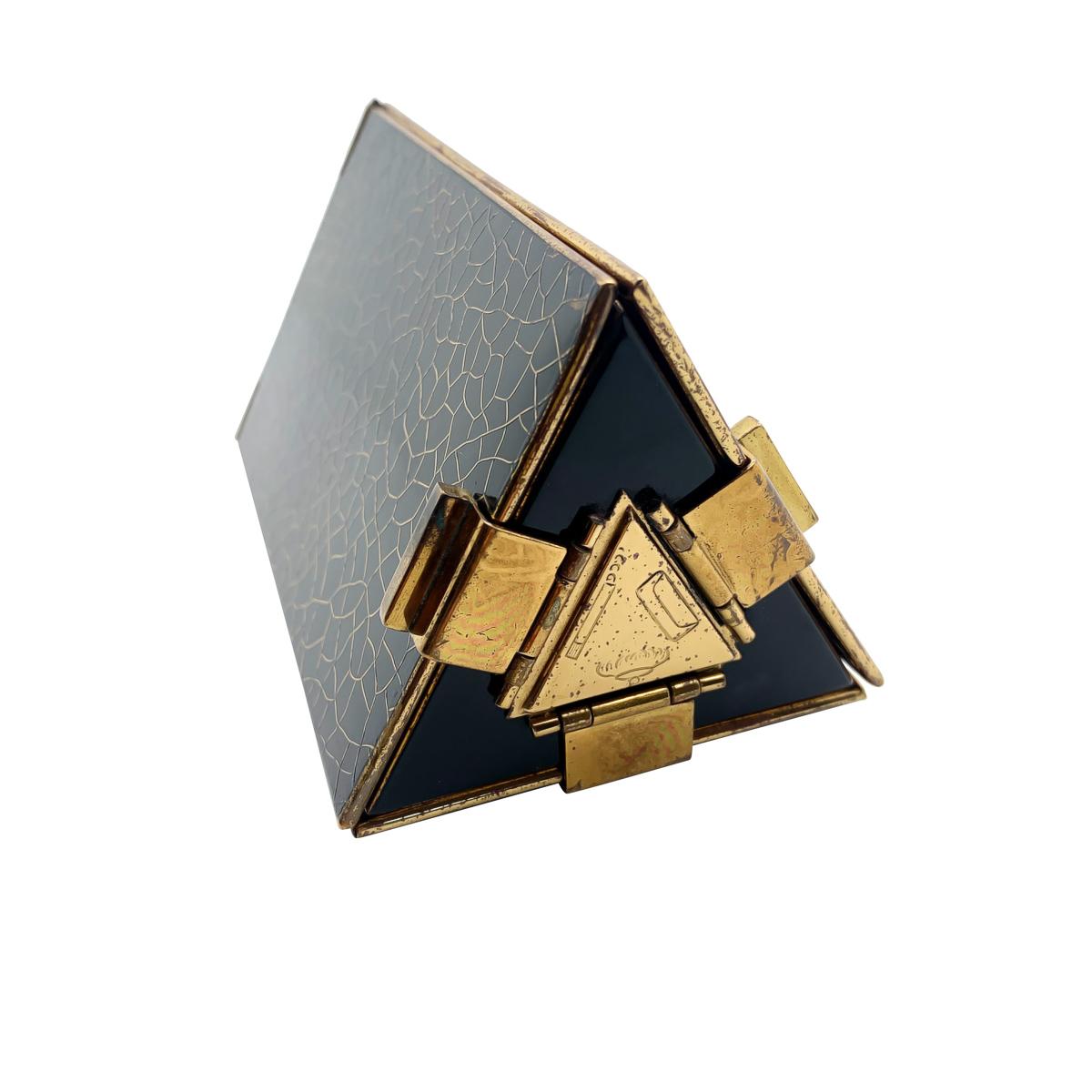 A rare and exceptional Art Deco Triangular Prism Minaudiere from the 1930s. Featuring a glorious amount of detail. Including a section for make up, cigarettes and notes/dance card. The base panel beautifully embellished with engravings indicating