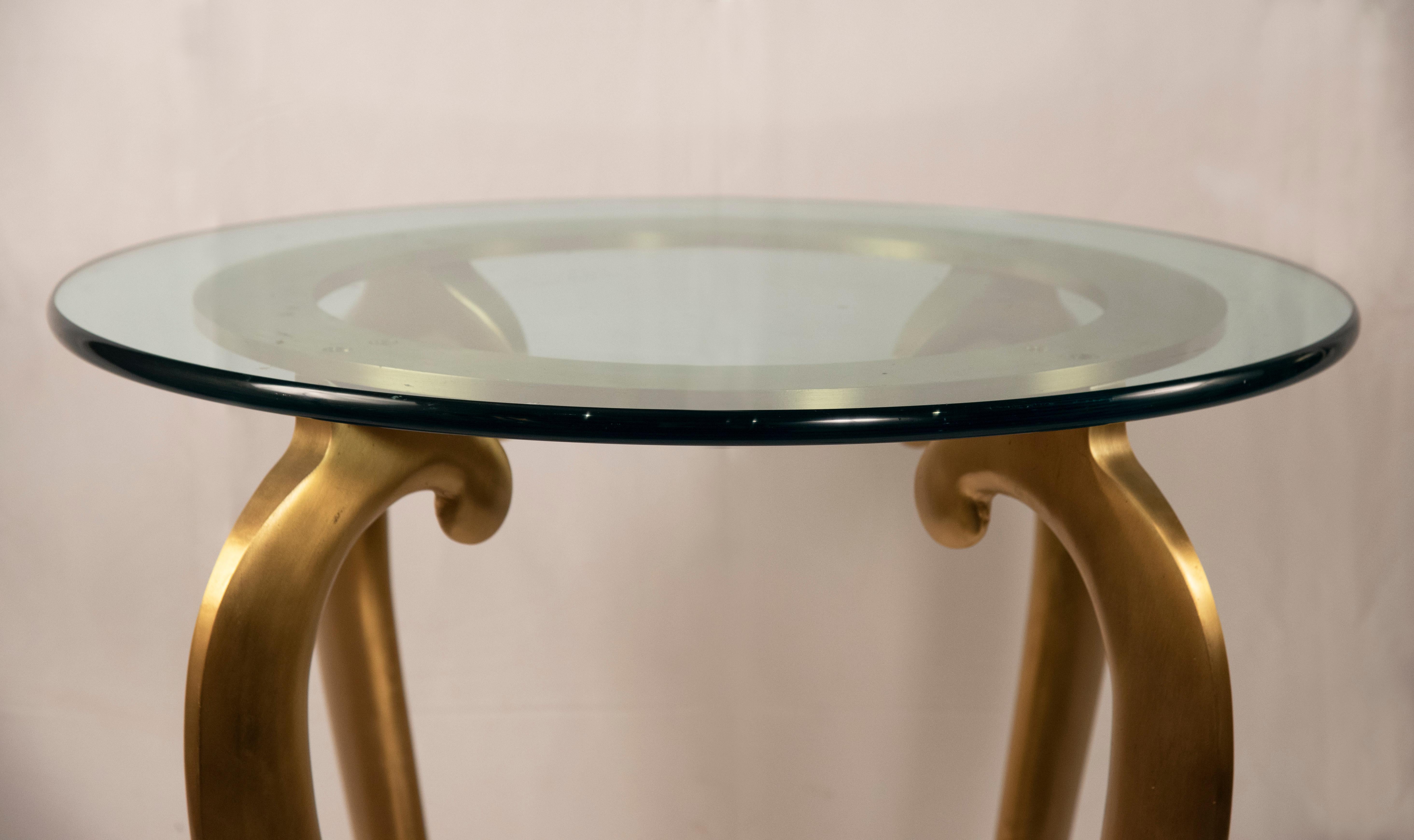 Curved golden legs with a separate glass top.