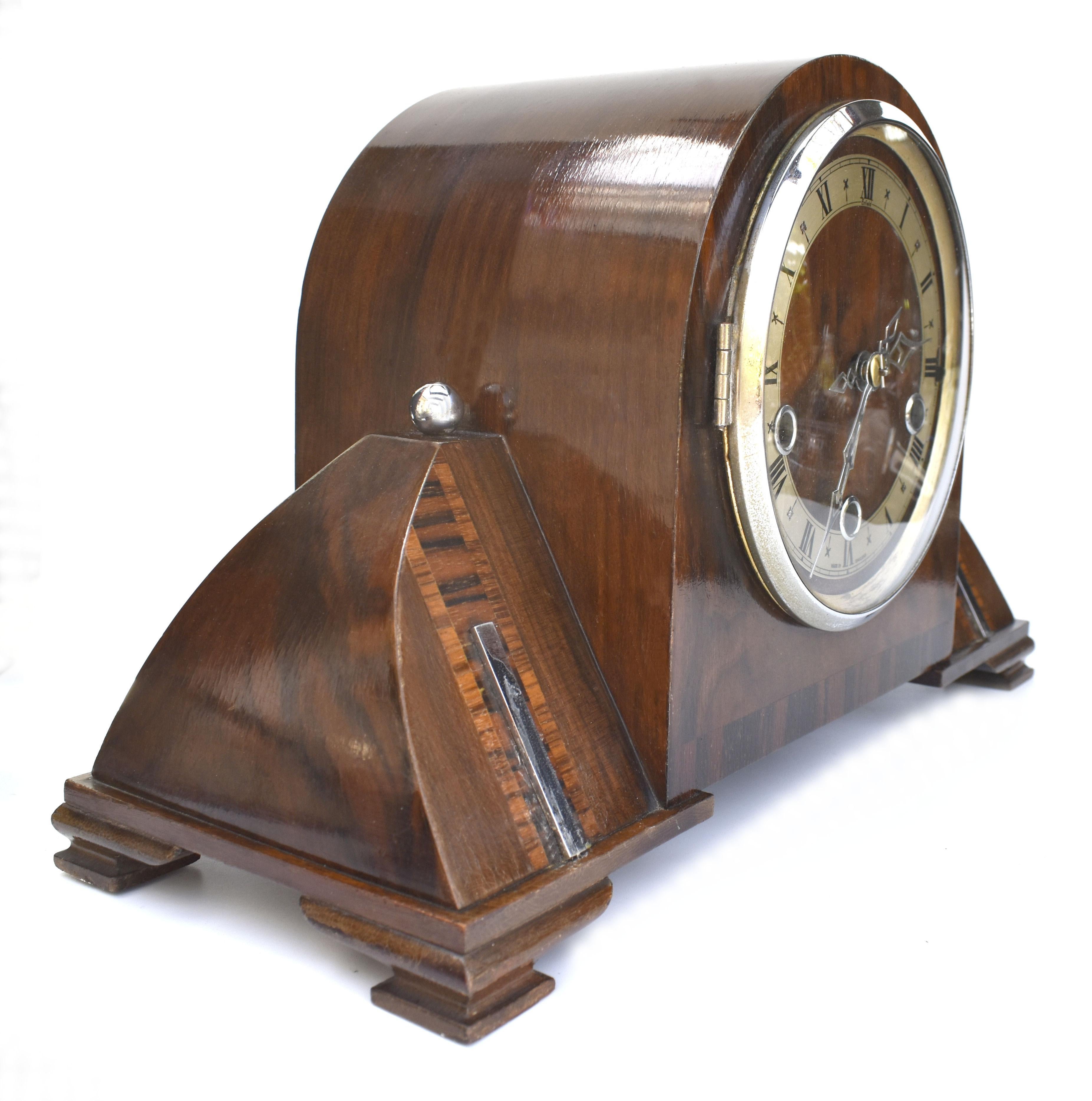 For your consideration is this fabulous early production Art Deco mantle clock by Enfield of England, a high quality clock with a beautiful pharaoh Egyptian revival Art deco design , Walnut case with veneer inlays and chrome accents . The clock has