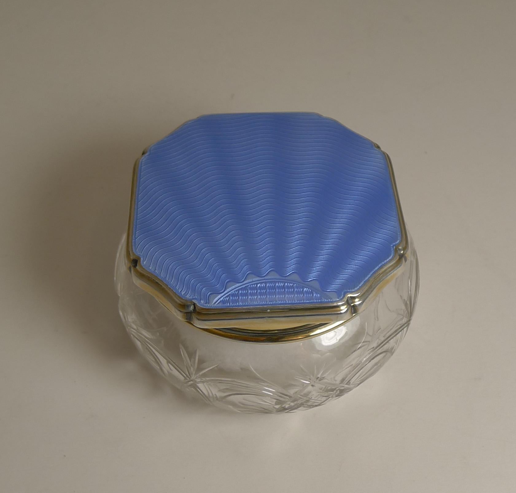 An exquisite Art Deco powder bowl by one of the finest quality English silversmith's, Walker and Hall of Sheffield.

The base is made from fine quality crystal with beautiful hand-cutting and a star cut underside.

The lid is made form
