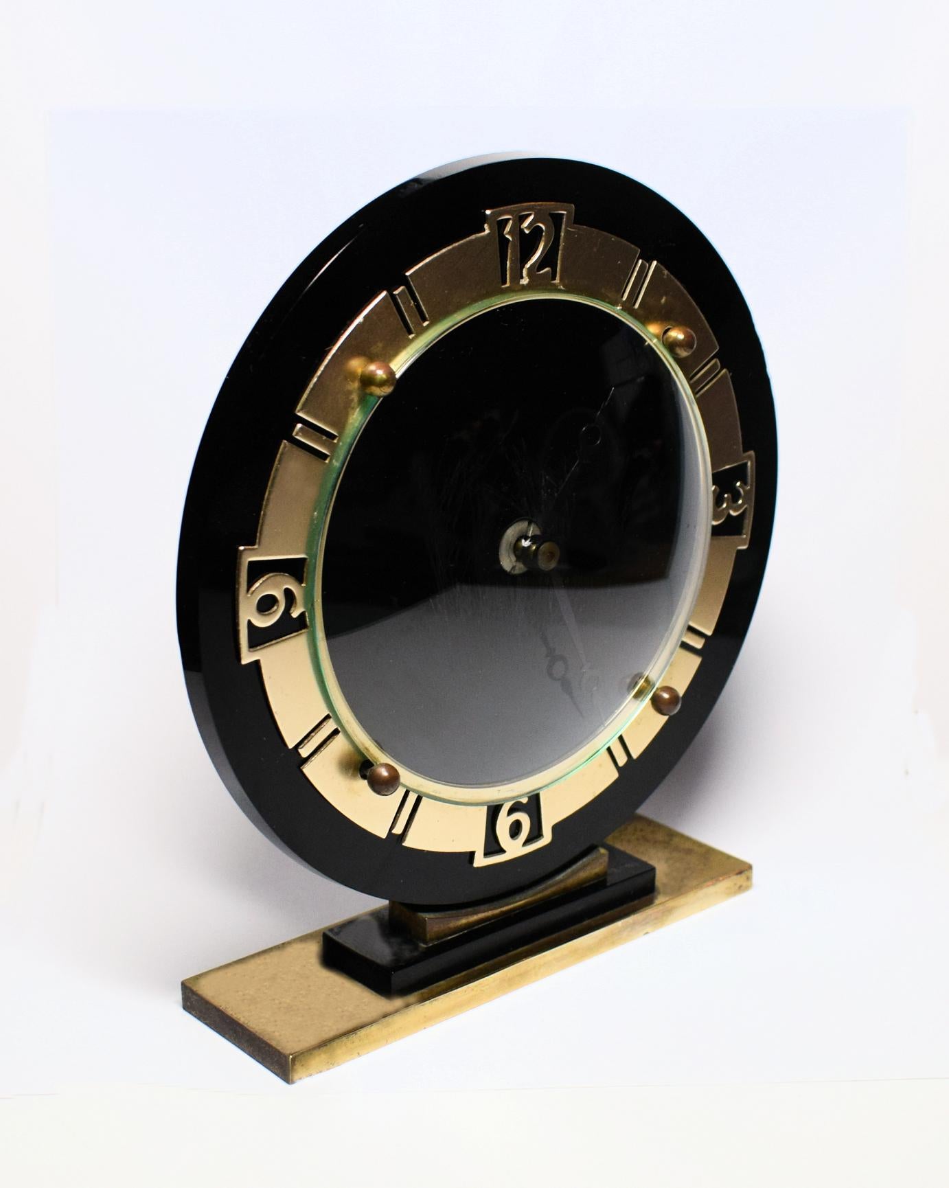 Art Deco English black glass clock dating to the 1930s. Lovely crisp and unblemished dial in a jet black vitralite glass, looks very impressive and ideal for most areas including mantle and desk. Gold tone bezel and plinth. Wind up movement which