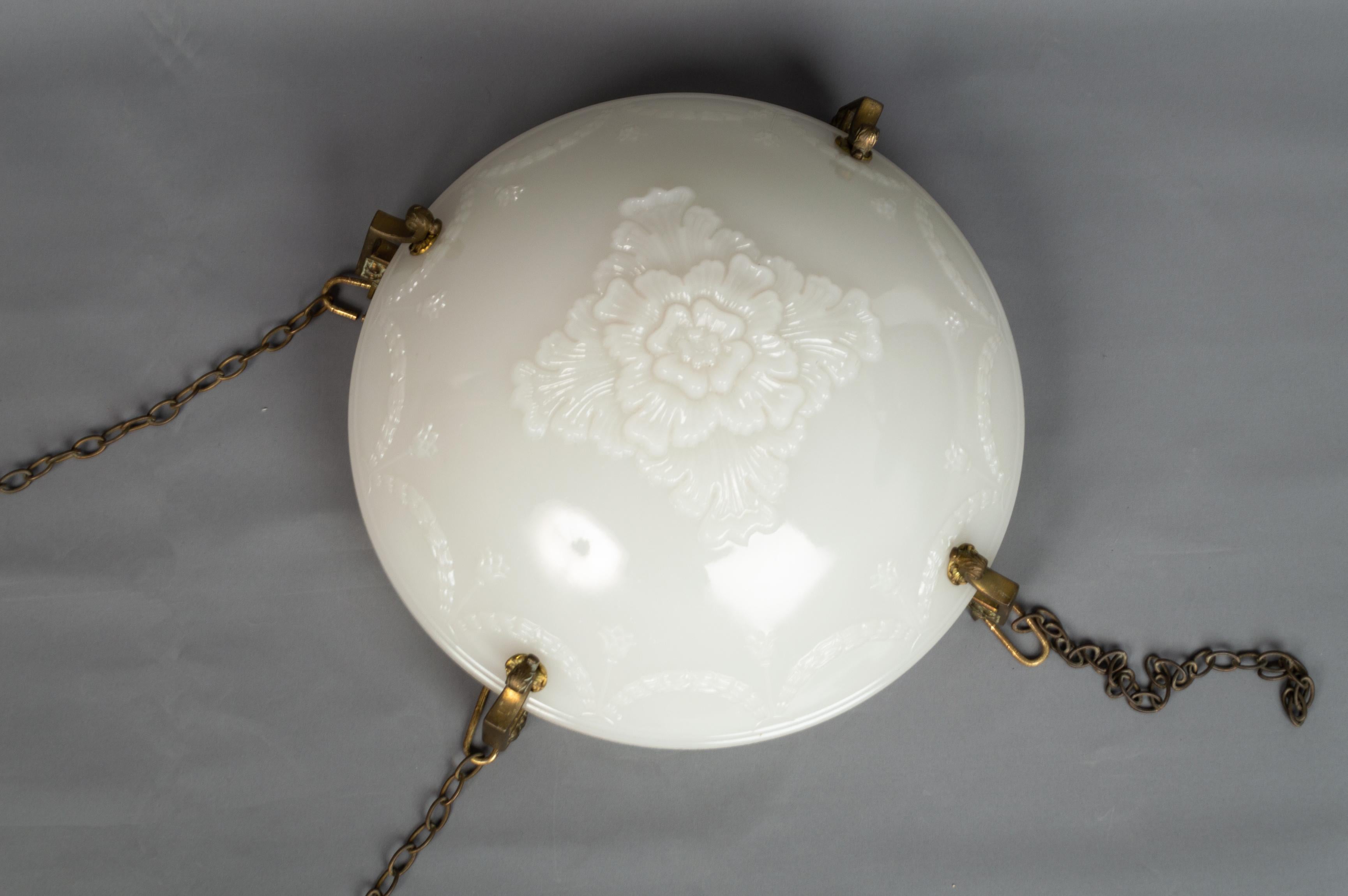 Art Deco English Jefferson moonstone glass plafonnier light pendant, C.1920.

A large Jefferson moonstone glass plafonnier, ?early 20th century, relief moulded with a central floral boss, enclosed by swag borders, with gilt metal mounts and
