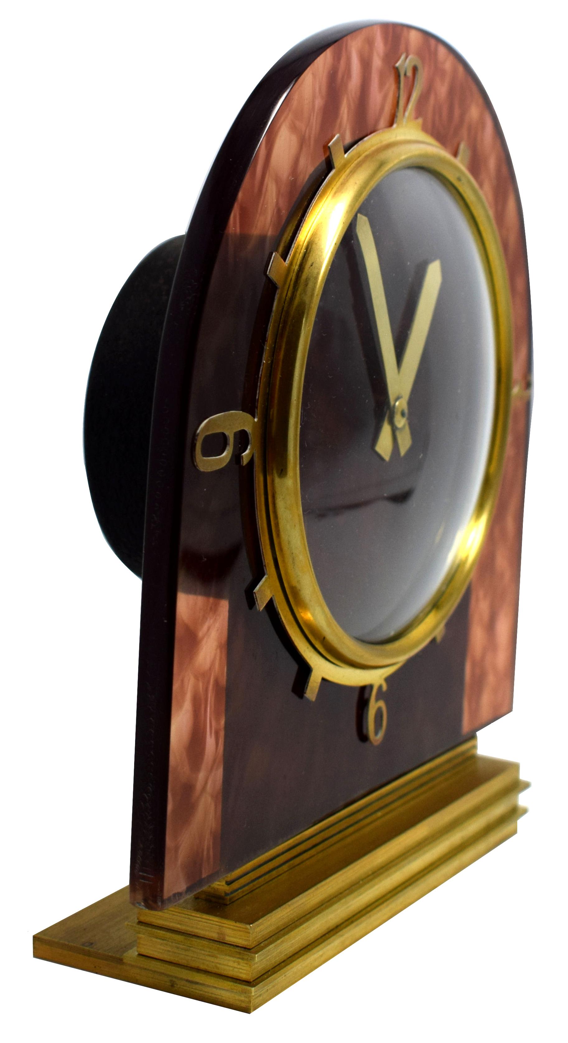Very attractive, compact desk clock from the early 1930s utilising early faux tortoiseshell Lucite and a Fine mechanical movement providing good timekeeping. Eight day movement which has been recently and professionally serviced. Stepped solid brass
