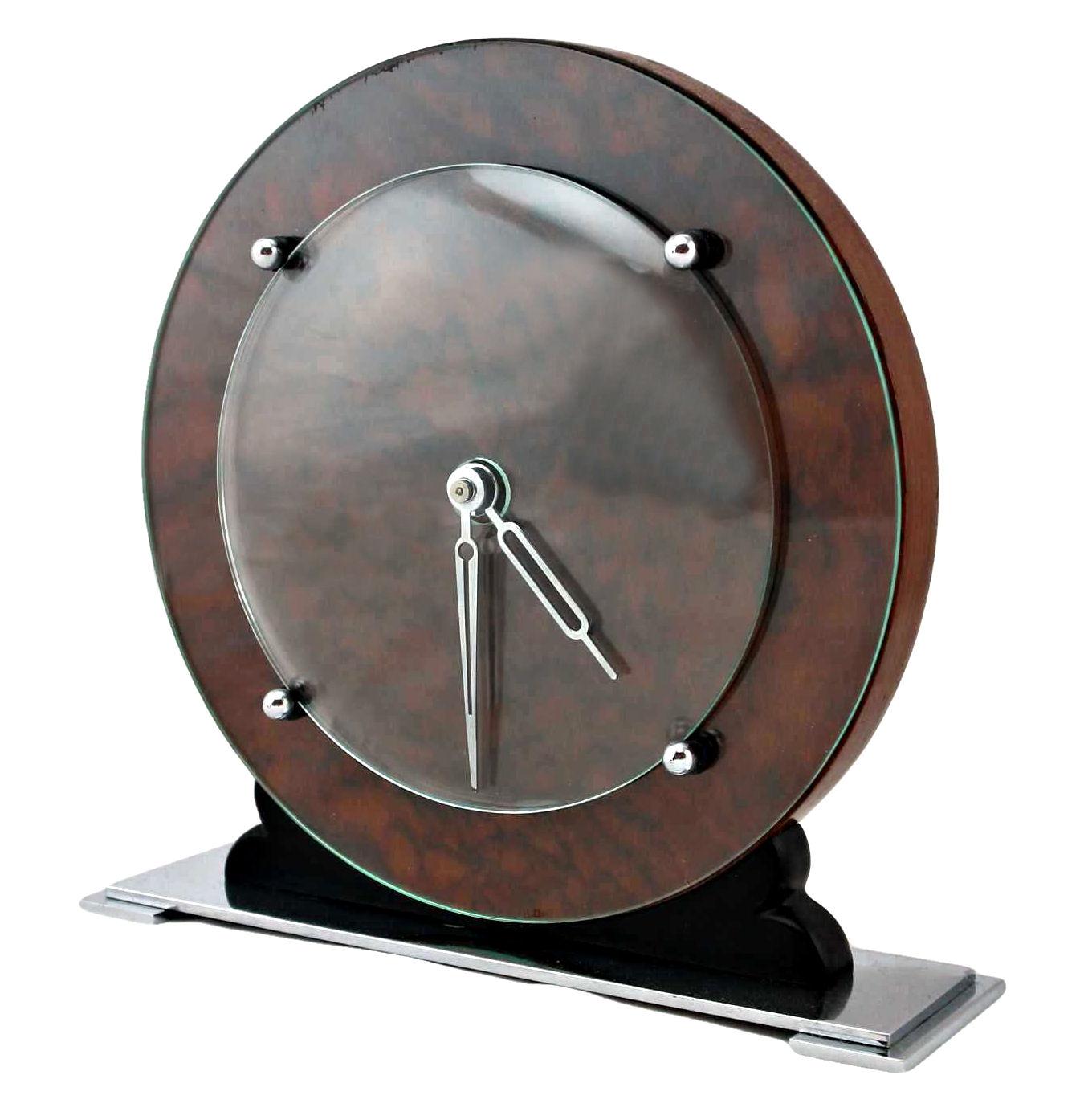 Superb and totally authentic 1930s Art Deco modernist manual wind up clock. Featuring a walnut dial and body with chrome hands and fixtures which are covered by domed glass, all resting on a chrome plinth. This clock oozes style, perfect for a desk