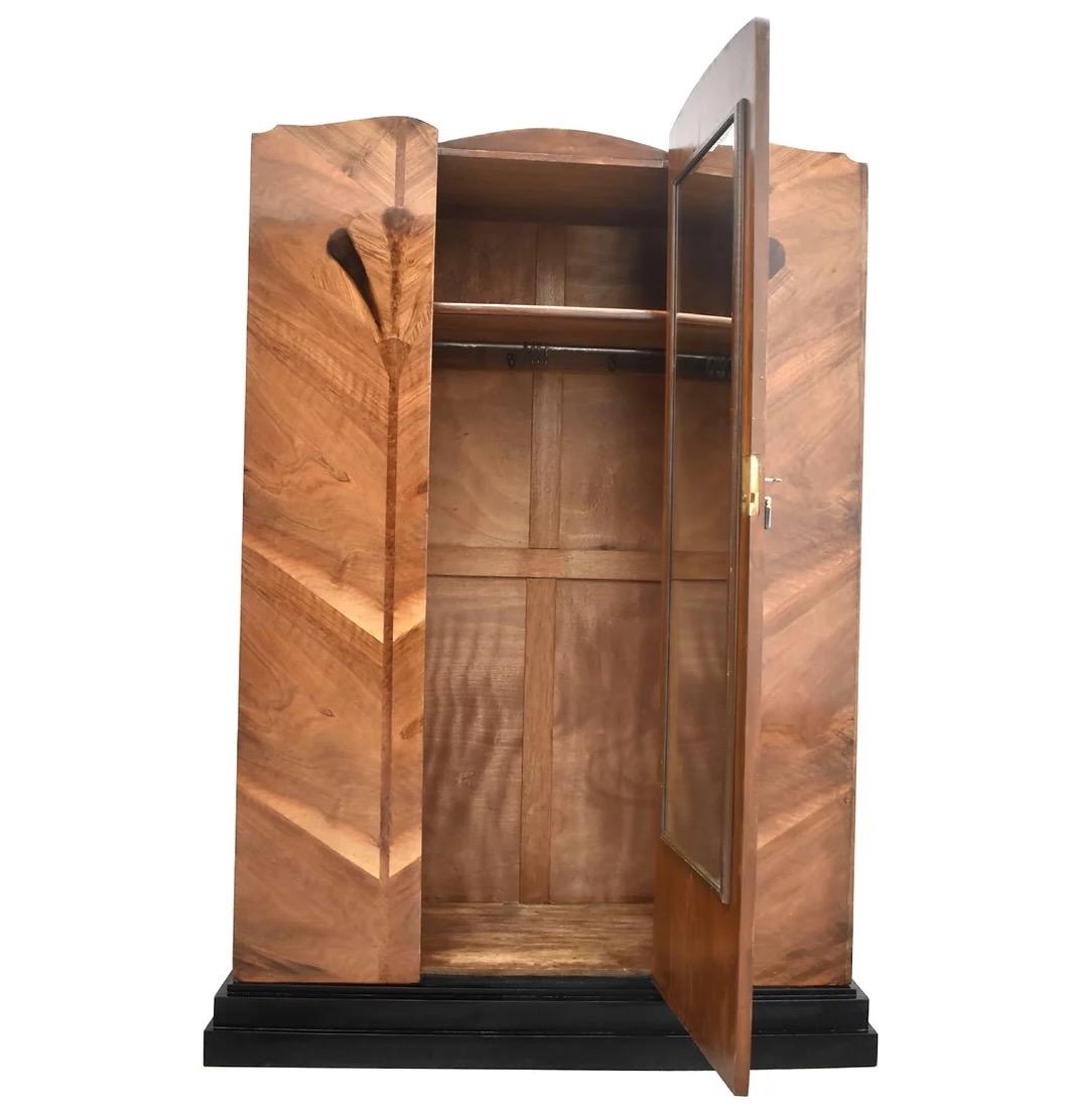 For your consideration is this wonderfully designed Art Deco wardrobe, totally authentic and originating from England. The main body is made from Mahogany and then various Walnut veneers making up the fan shaped motifs to the patterned doors, the