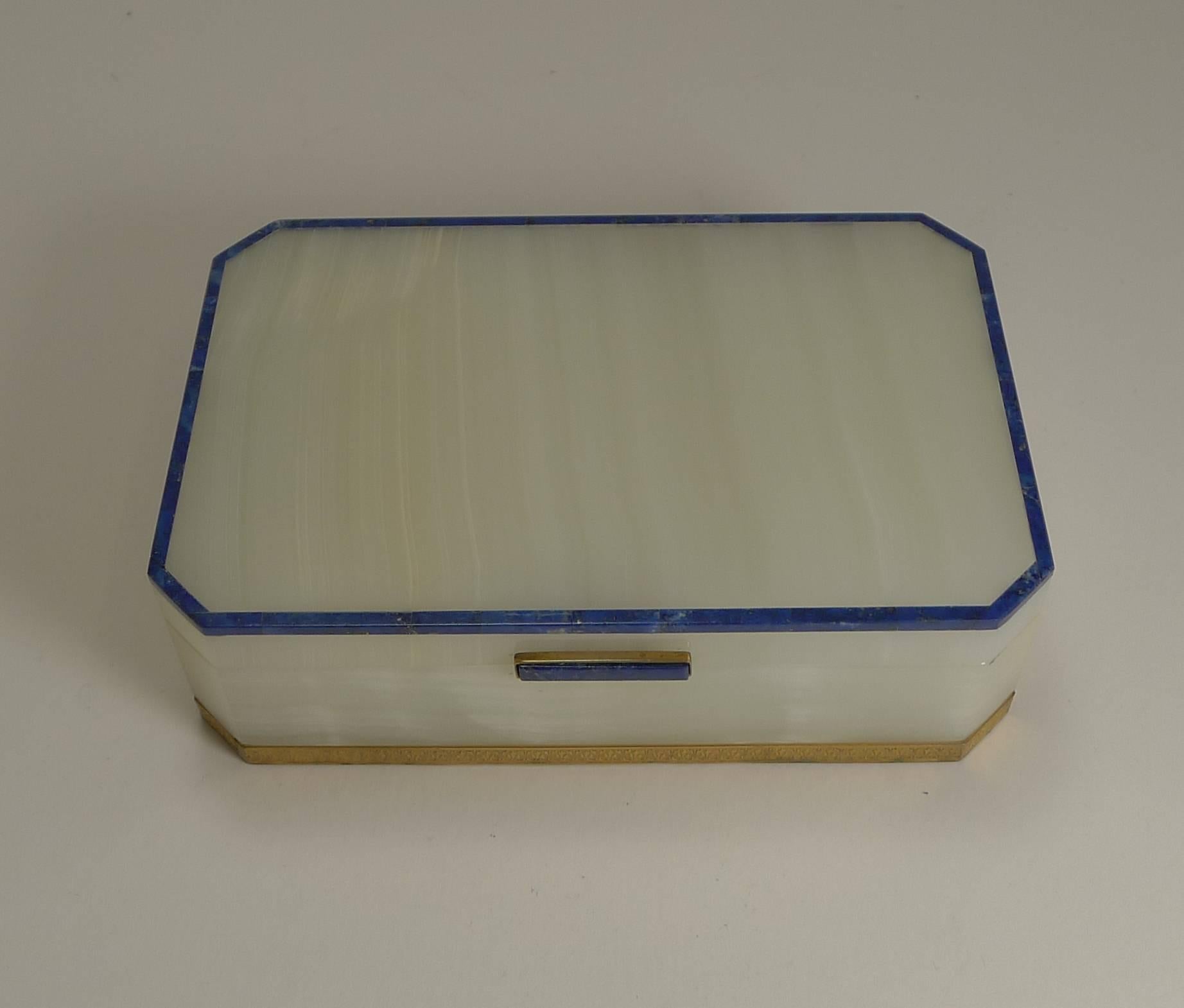 A truly smart and elegant box in polished white onyx and trimmed in Lapis Lazuli.

Art Deco in era, dating to circa 1930/1940 the box is marked by the English silversmith H G & S for Henry Griffiths and Sons. Most of these boxes were trimmed in